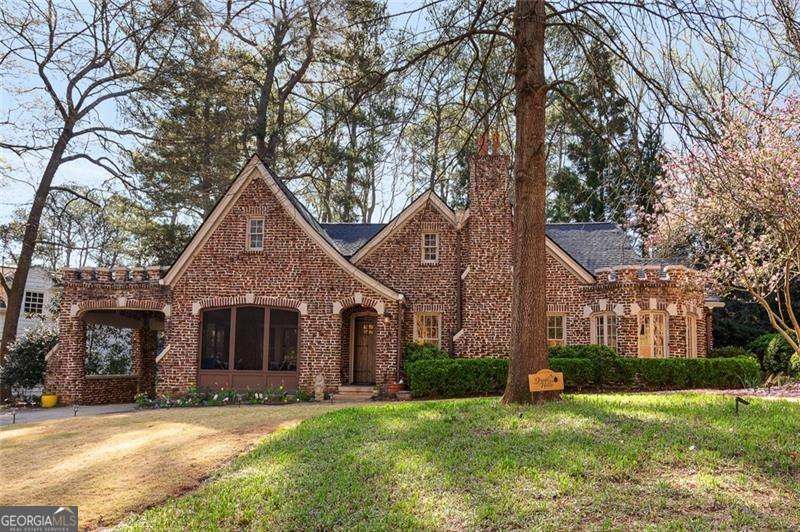 Stunning clinker brick home in historic Druid Hills, just steps from Emory Village and Peavine Park Trail. This fully furnished, meticulously renovated 1920s residence features a heated pool with maintenance and pest control included in the lease. Blending modern upgrades with vintage charm-original dining tile, picture rail molding, and art lights-the main level offers multiple living spaces including a fireplace-front living room, rounded sitting room, screened porch, and fireside family room overlooking the pool. The chef's kitchen includes a Thermador range, new Bosch appliances, custom island, dual pantries, and marble pastry area. The spacious dining room seats 12+ with extra seating in the basement. The main-level primary suite includes a renovated bath with jetted tub, luxury shower, dressing room, and walk-in closet. Upstairs has two bedrooms, a loft office, and a secret recreation room hidden behind a bookshelf. The waterproofed basement features workout equipment, extra fridge/freezer, and ample storage. Fabulous yard with raised garden beds, koi pond, bird and wildlife sanctuary, and a private fenced backyard with a pool area, deck, grilling porch, and fire pit. Additional comforts include a whole-house air purifier and generator. Experience this captivating Druid Hills gem today!