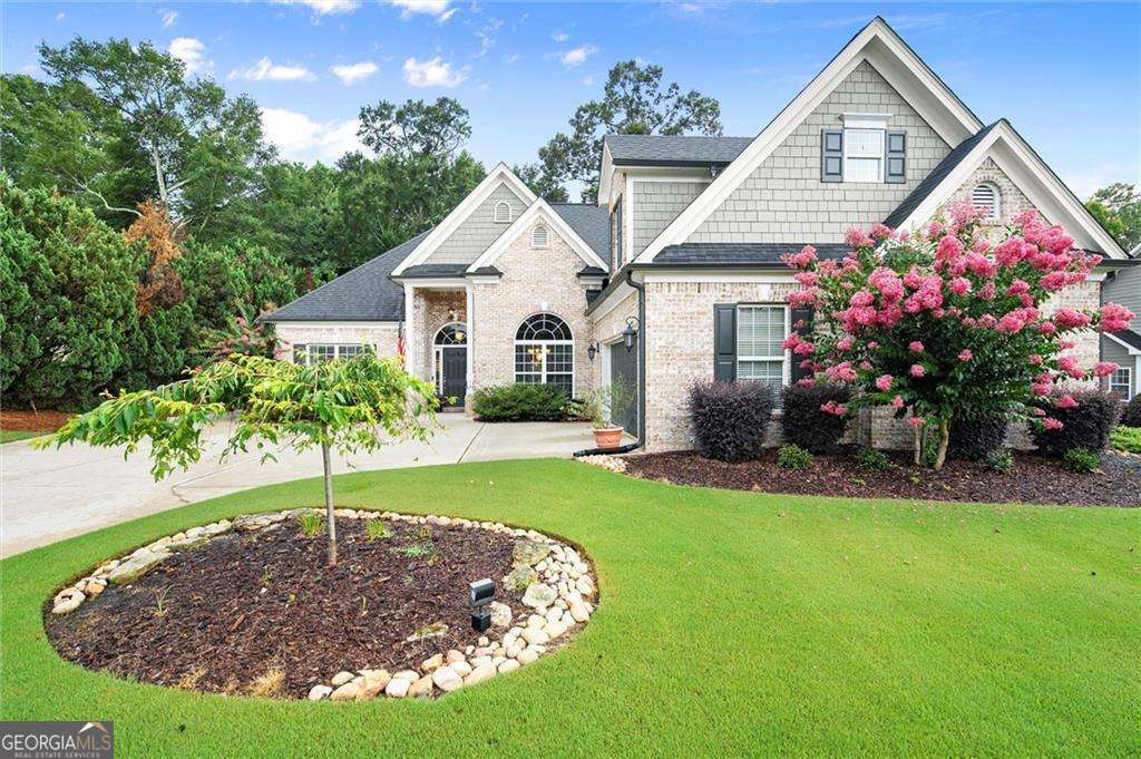 Welcome to your dream home in the sought-after, peaceful Alcovy Bluffs swim and tennis community! This beautifully maintained 5BD/3.5BA, ranch-style home offers the perfect blend of comfort and functionality with 3-sides brick and thoughtfully designed floorplan. This home offers tons of curb appeal, 2-car garage, and ample parking. Step inside to a bright and airy open-concept family room, dining area, and kitchen which flow effortlessly, ideal for everyday living and entertaining. The kitchen features a breakfast bar, eat-in nook, sleek granite countertops, stainless steel appliances, gas range, pantry, and tons of cabinet space. The spacious primary suite on the main level is a true retreat, complete with a recently renovated spa-like bath, and large walk-in closet. Enjoy the convenience of a separate laundry room just steps away from the primary suite! The split-bedroom layout offers optimal privacy with 2 additional bedrooms and full bath located on the opposite side of the home. Upstairs you will find a versatile space that can serve as a bedroom/office/media room, along with a 5th bedroom, full bath, bonus area, and abundant storage space. Enjoy outdoor living at its finest in the private fully fenced backyard, boasting a gorgeous screened-in patio with gas fireplace, covered grilling area, hot tub, and beautiful landscaping complete with irrigation. New HVAC downstairs in 2021 and new HVAC upstairs in 2023. With numerous upgrades throughout, this home truly combines craftsmanship, comfort, and convenience. All this just minutes from shopping, dining, and major highways for an easy commute. Move-in ready and waiting for you to call it home!