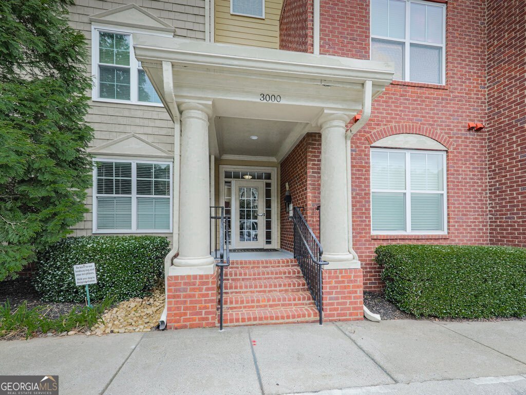 Come and see this gem at the Flats at Riverwalk, a serene neighborhood nestled in nature and an easy walk to the Chattahoochee river and Silver Comet trails. This updated, immaculately maintained, FIRST LEVEL, 2 bedroom, 2 bath END UNIT boasts easy living. Enjoy granite countertops in both the secondary bathroom and primary ensuite. Relax in the primary soaking tub after a long day or grab a shower in the primary ensuite. Dealer's choice! Luxury vinyl flooring throughout, gorgeous entertainer's kitchen with grey cabinets, newer stainless steel appliances and hightop bar. Mood-setting, double-sided gas fireplace between living room and dining room, and both front door and patio door keyless entry included for energy efficiency and security. Flock security cameras upon entrance to this community. HOA covers pool with outdoor showers, grill area, gas, community landscaping, pest control, trash, water and clubhouse. Every detail has been attended to in this gorgeous slice of heaven! Two tandem, deeded and permitted parking spots just past the elevator make it super easy to transport groceries and goodies to the first floor. So many great restaurants and entertainment nearby like Truist park for those baseball lovers out there or the Cobb Energy Center for the lovers of art. Super easy access to 75 and 285 for effortless commuting! Do NOT miss your opportunity to own this immaculate sanctuary surrounded by nature and good vibes!