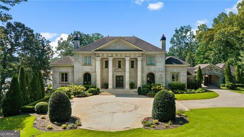Classic Greek Revival architecture, a lush 2.2 +/- acre lot and new over-the-top backyard oasis are just a few of the reasons to fall in love with this stunning home. Attention to detail is found throughout with carefully chosen upgrades including a cast stone fireplace, hand-scraped floors, rustic hewn beams along with numerous stone surfaces including travertine, marble & limestone. Primary suite on main with access to covered outdoor patio, fireplace, large walk in closet, double vanity, sep shower/tub. Kitchen is open to a cozy keeping room. Featuring every amenity expected in a home of this quality, the terrace level features a wine cellar, theatre, billiards, home gym and convenient guest suite with a private patio. The show-stopping backyard offers lit tennis courts, a saltwater pool/spa, in-ground trampoline, putting green and built-in grill. Spacious en-suite secondary bedrooms. Additional enviable features included elevator access to all levels, a 3 car garage, whole house generator, gated driveway, and coveted location close to top public and private schools, Chastain Park and everything Sandy Springs and Buckhead have to offer.