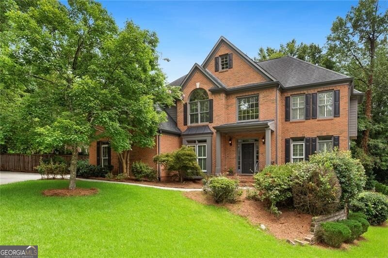 With its fantastic use of space, unbeatable Brookhaven and Buckhead convenience, and sought after Pine Hills address, 1151 Goodwin Road is sure to check many a box. Welcome guests into the grand, two-level entry foyer where gleaming solid oak hardwoods lead to a spacious main level ideal for entertaining. Host guests in the bright open concept kitchen/breakfast/family room where custom under-lit 42-inch cabinetry offer ample storage. For the chef of the house, enjoy the stainless gas cooktop, double oven, microwave, dishwasher, and brand new french door refrigerator/freezer. The generous kitchen island offers seating for three while the bright, bay window-lit breakfast nook offers views of the tranquil back yard and access to the expansive rear deck. With its grand cathedral ceilings, marble surround fireplace, and two levels of windows, the open and airy family room affords ample room for hearthside conversation. Create timeless memories serving meals in the formal dining room with seating for 8 while the foyer-adjacent formal living room offers sanctuary for holiday memories or restful reflection. Opposite the foyer from the living room, beautiful French doors lead to a fantastic home office or reading room. A convenient mud room with stackable front-load washer/dryer and custom storage leads to the two car garage with sink and workshop space. Retire to the oversized second-level owners suite with its extra-high tray ceiling and beautiful palladium window. French doors open to a primary bath that is sure to calm with separate jetted soaking tub and shower with frameless glass surround, separate vanities, and private water closet. Three walk in closets offer convenient storage for off-season couture. Guests can enjoy the comfort of their own ensuite bathroom and walk in closet while the Jack and Jill suite offers a privatized toilet and shower room flanked by separate, bedroom-adjacent vanities. Expecting extended stay visitors? The expansive day-lit and walk-out terrace level boasts over 1,800 square feet of living space with new LVP flooring, kitchenette/serving area with sink, new shaker cabinetry, marble countertops, and designer backsplash, closet-hidden refrigerator/freezer, separate sleeping quarters with two large walk-in closets, a full bath, and additional flex space for storage, home theater, or gym. Newer mechanicals, fresh paint throughout, LED lighting, and new carpeting with plush padding complete this amazing in-town address with lower DeKalb taxes! Just minutes from Buckhead and Brookhaven dining and retail, CHOA, Emory, and the CDC. Looking for pool time to cool off during the heat of the summer months? Convenient to Pine Hills, Roxboro Valley Swim and Tennis Club is a quick two minute drive. Recreation and athletic fields await at nearby Shady Valley Park. Enjoy the convenience of quick access to I-85, GA400, and MARTA accessibility from nearby Lenox or Brookhaven Stations. Your new address awaits at 1151 Goodwin Road!