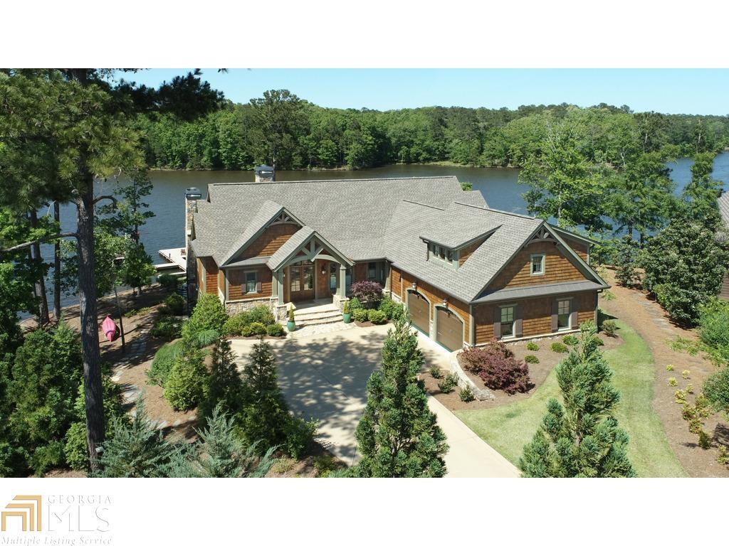 Surround yourself in the natural beauty of world-class Reynolds living in this custom lake house completed early 2018. Located just 90 minutes from Atlanta & international airport, Reynolds offers luxurious family friendly facilities, restaurants, 6 golf courses, Sandy Creek sports complex all surrounding the beauty of Lake Oconee. Classic lake house design w/stained cedar shake & stone is in the desirable Richland Creek area w/deep water. The Lake Club, Marina & Ritz Carlton are all a short boat ride away. Set on the point of Angel Pond E. w/ spectacular water viewson 3 sides & privacy.Main floor offers open floor plan, custom cabinets, vaulted ceilings, arched beam accents-á& Wide plank pine floors. The Chefs Kitchen w/ island, gas cooktop, walk in pantry & adjacent-ácasual family dining area are all open to the fireside great room that opens up to the stunning Screened Porch w/ gas stone fireplace & additional dining area overlooking the lake. Fireplace mantles are reclaimed antique beams. -áOwners Suite on the Main Level has vaulted ceilings, arched beams, private balcony & spectacular lake views. Ensuite bath w/double sinks, lavatory room, walk in closet. Additional bedroom/Office w/ EnSuite bath on the main level with French doors onto screened porch.-á Terrace level is open to the yard w/stone gas fireplace & has a large rec room with wet bar, separate game room with pool table. In addition, it-áhas 3 more bedrooms each with their own-ábathrooms-á& Lake Views.-á-áAdditional Suite above the garage has Ensuite bath, walk-in closet & storage.-áSaltwater pool is of a size that can easily be heated for use in a couple of hours year-round. Dock and beautifully landscaped yard await you. 4 HVAC, dual gas tankless water heaters. Golf membership Available