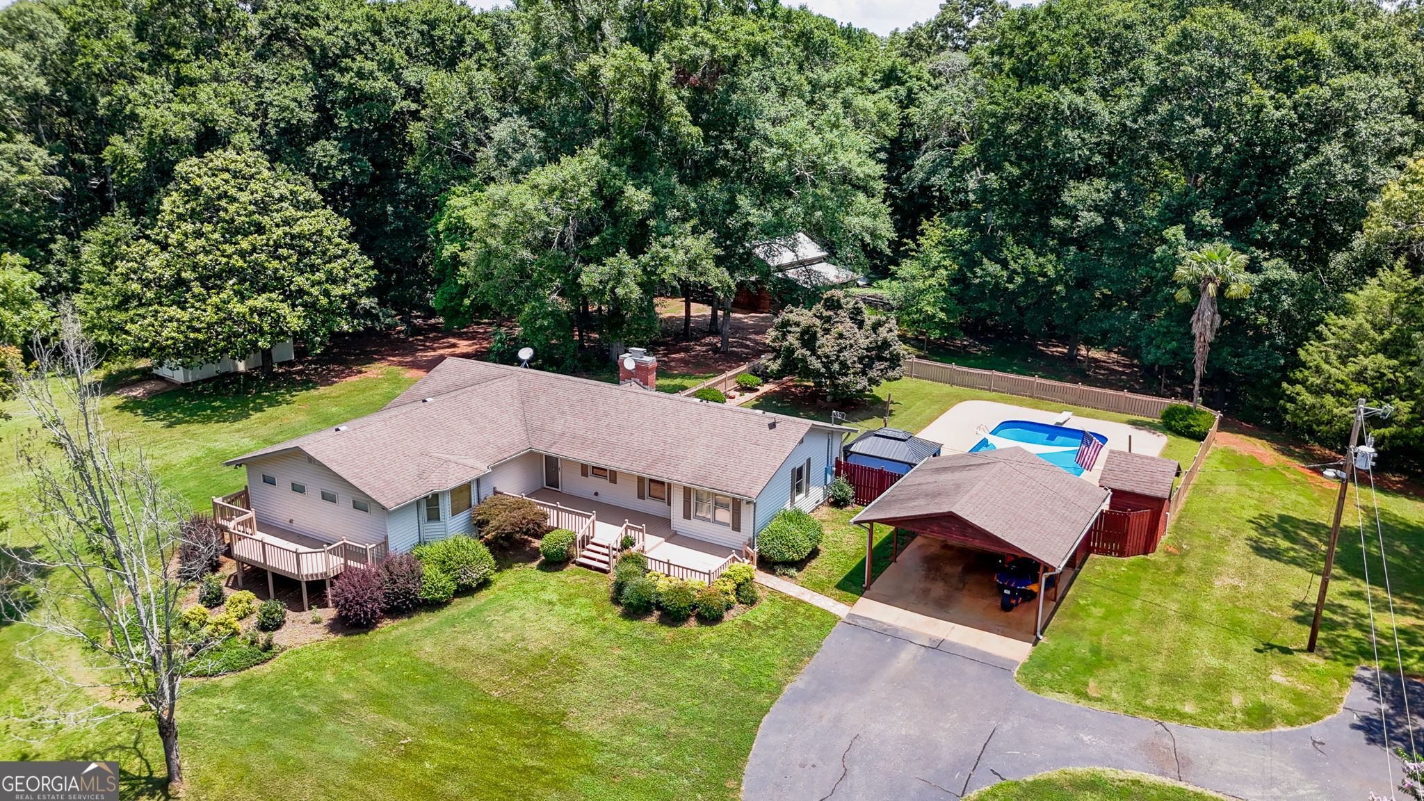 31.65 +/- private acres! Awesome sprawling one level ranch offering 4 bedrooms and 3 full baths with awesome outdoor space, including multiple porches, an inground pool, great patio space, covered grilling area, and a huge barn/shop with room for your future mini-hobby farm! Wind down your drive to a beautiful setting - the home is not visible from the road! Living areas include a formal foyer entrance, a large family room with fireplace that opens to the dining area, and a spacious kitchen. The spacious 480 +/- square foot master suite features a private deck, where you can enjoy gorgeous views of your property. The suite also boasts a luxurious in-room jacuzzi tub for ultimate relaxation, an ensuite bath with tile floor, an oversized tile shower, large vanity, and a big walk-in closet. One of the secondary bedrooms includes a private bath, making it ideal for a teenager or second master suite. On the opposite end of the home, there's a secluded 4th bedroom that's perfect for a private home office if needed. The home showcases stunning hardwood floors and updated tiled bathrooms throughout. The updated kitchen is equipped with solid surface countertops, plentiful cabinetry, and stainless-steel appliances. In addition there's a full size laundry room and an additional mudroom coming off the pool/outdoor area. The inground pool area is a dream for entertaining, with a pergola area, plentiful concrete patio space, and a covered space off the backside of the carport that faces the pool that's perfect for grilling and gathering. The pool area & immediate backyard area is fenced in. There's a small firepit and homemade wood fire pizza area too. A charming 6x8 pool pump house offers convenient storage for pool supplies. The front of the home offers a huge deck and a separate private deck from the master suite. Additional features include a 16x24 barn with concrete floors and electricity, numerous chicken pens/livestock areas, and a 12x24 storage building with power. A secluded loop asphalt driveway leads to a carport with parking for two. The acreage is absolutely gorgeous and has trails for riding and enjoying. Quiet rural location just outside of Thomaston. This rare property is a must-see!