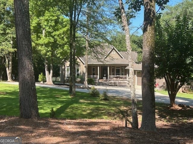 This move-in-ready home offers a beautiful blend of elegance, privacy, and natural beauty. Enjoy quiet mornings or evening gatherings on the expansive lanai, which overlooks a serene pond and provides the perfect setting for outdoor dining. Inside, you'll find White Oak solid hardwood floors throughout, adding warmth and character to every room. The home sits in a tranquil, private location with newly updated landscaping, a circular driveway, and a two-car garage for added convenience. Stylish, modern lighting enhances the ambiance, and access to a community pool adds to the appeal. While club membership is not included, the home boasts a wealth of exceptional features that make it truly special. Please note: a few of the images have been virtually staged to help illustrate the home's potential.