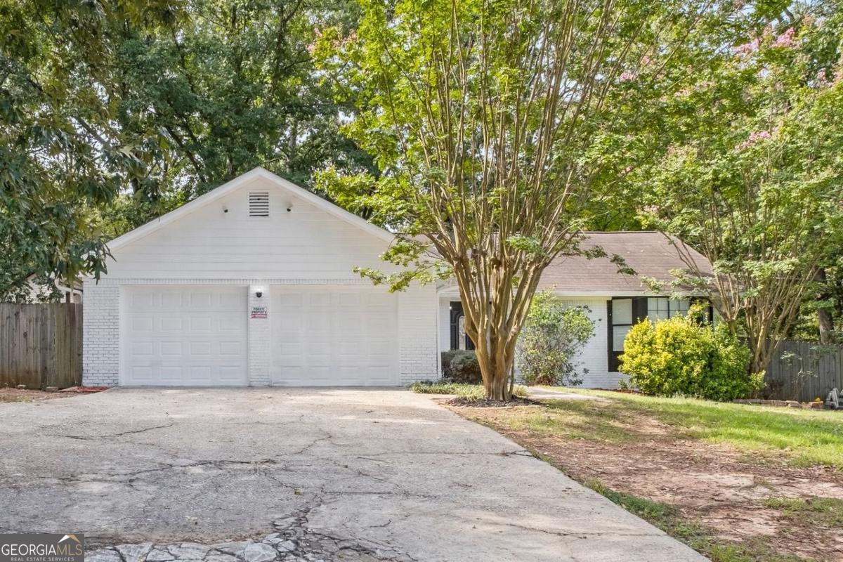 ***Home qualifies for up to $25,000 "no repayment grant" as well as 100% financing with preferred lender*** Welcome home to this beautiful four-sided brick ranch-style home featuring a spacious open floor plan, three generously sized bedrooms, a two car garage, a large fenced in backyard and more! Featuring brand new wall-to-wall carpeting and fresh paint throughout the entire inside and outside of the house. Also featuring all stainless steel appliances, and a newly updated deck. The large living and dining areas feature a cozy wood-burning fireplace creating a warm and inviting atmosphere. Enjoy three generously sized bedrooms offering both comfort and privacy. The oversized master suite includes a bright and airy bedroom and a spacious en-suite bathroom. Enjoy the fully fenced-in backyard, ideal for entertaining, gardening, or unwinding in privacy. The large two-car garage also adds convenience or the option of extra storage. Located just minutes from the interstate, Publix, Home Depot, Best Buy, AMC Theater, and Atlanta Hartsfield Airport, this beautifully updated home offers the perfect combination of comfort, style, and location. Schedule your showing today.