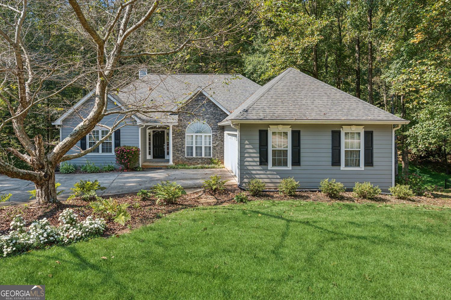 Perched among the trees like your own private treehouse, this beautifully maintained ranch home with a finished terrace level blends timeless charm with thoughtful design. Enjoy your morning coffee on the deck surrounded by nature, all with the ease of a low-maintenance backyard. Inside, the welcoming split-bedroom floorplan begins with a formal dining room featuring crown moulding and a tray ceiling, perfect for hosting gatherings. Hardwood floors span the main level, with new carpet in the bedrooms adding warmth. The living room highlights a tray ceiling, a marble surround wood-burning fireplace, and double doors that open to the back deck, seamlessly blending indoor and outdoor living. Heading to the kitchen, you will find a bayed breakfast room for your more casual dining. The kitchen features a decorative backsplash, a Kitchenaid stainless steel refrigerator, a GE electric oven range, a Bosh dishwasher, a double sink, a pantry closet, recessed lighting, and a smart lazy susan cabinet. The primary suite is a true retreat overlooking beautiful mature hardwood trees. It features new carpet, a tray ceiling, and an ensuite bath featuring two separate walk-in closets, a double vanity, jetted tub, and a separate shower. A Jack and Jill bath connects two additional bedrooms on the main level, while a half bath is conveniently located off the hallway for guests. To give buyers even more opportunity to personalize, the sellers are offering a $500 flooring allowance toward the bathroom flooring of the buyer's choice. The finished basement/terrace level expands the home's living space with a large recreation room that opens to a covered deck and the private wooded backyard. A dedicated office/bedroom with a closet, a full bath with shower, and an additional oversized bedroom with bay windows and crown moulding - provides flexibility for work, hobbies, or extended family. Two unfinished portions of the basement create endless possibilities, ideal for storage, a home gym, or workshop space. The exterior was refreshed in 2022 with new siding, a full repaint, and features stone accents, giving the home outstanding curb appeal. That same year, the sellers also installed a new insulated garage door, adding both efficiency and style. Energy efficiency continues inside with an updated HVAC unit on the main level that was replaced in 2017. A two-car side-entry garage leads into a convenient mudroom with laundry and a storage closet, keeping daily living organized and practical. Outdoor living is equally inviting, with steps leading down to the serene, wooded backyard that ensures both privacy and natural beauty. Homeowners will also enjoy access to desirable HOA amenities, including a pool, tennis courts, playground and community pond. New Cherokee Bluff Schools.