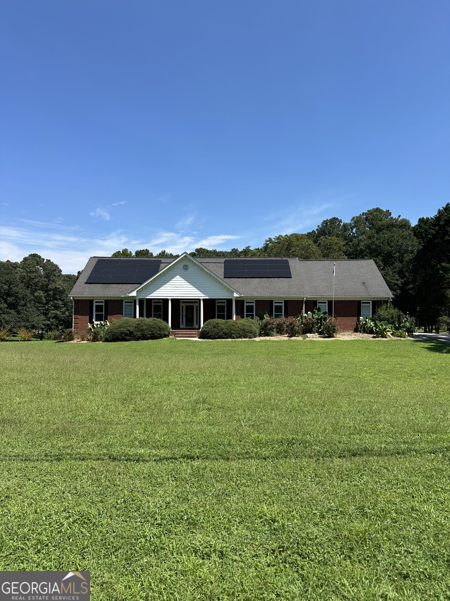 Bring the family & the animals to this small Gentleman's farm! A bit of country but so close to the city-easy commute! 4-sided all brick ranch located on 4.5 acres includes barn with workshop, hay room and stable, included 3 fenced pastures completely fenced in allows you to raise animals. There's plenty of room to add a pool, garden, playhouse or whatever you may want to complete your outdoor living. The possibilities are endless as no HOA. Inside the home you'll find a kitchen the whole family can gather to cook in together or sit and visit while you cook. The hardwood floors are in tip-top condition and are through out the home. Make the sunroom you're sanctuary. It looks over the peaceful private property and has adjoining deck. You'll also find a complete finished in-law suite in basement with living room, fireplace, full kitchen, full bath and additional bedrooms. There's also additional storage in the basement. Additional extra's include 6 person newer hot tub, pellet stove, 3 yr old solar power system (lower power bills!!) handicap accessible with 36' doors, 4 car detached carport, Interior freshly painted in July 2025, Basement LVP July 2025 - Well sought after Archer School district! You'll fall in love with this hard to find All Brick ranch on acreage!! This one won't last!