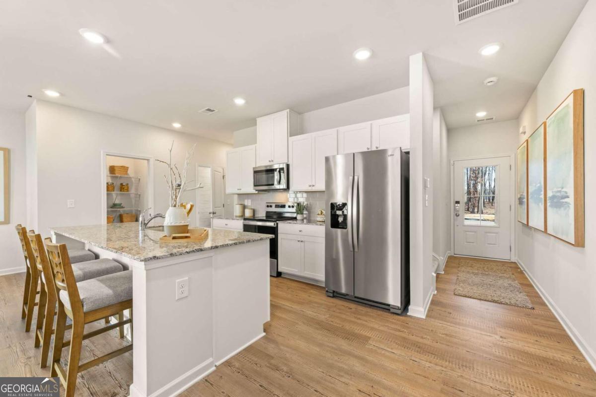 ++END UNIT++Welcome to Century Communities newest neighborhood featuring beautifully appointed 3 bed/2.5 bath townhomes.  Home features upgraded flooring throughout the main level as well as laundry and baths, granite countertops, stainless steel appliances, blinds and a beautiful floor to ceiling shiplap fireplace with multiple settings.  See why our homes are extremely sought after...Not only are the homes beautiful, but the location is amazing...walking distance to The Gwinett Braves stadium, top golf, the exhange at Gwinnett and so much more.  The mall of georgia is four minutes from our location.  Introductory pricing has been established, but hurry before pricing starts to increase.  Come see as soon as possible.  Ask agent about financing through our preferred lender Inspire Home Loans.  All applicants must prequalify with our lender regardless of who they chose for their loan.  All incentives are tied to prefer lender only.  Hurry, this neighborhood will sell very quickly.