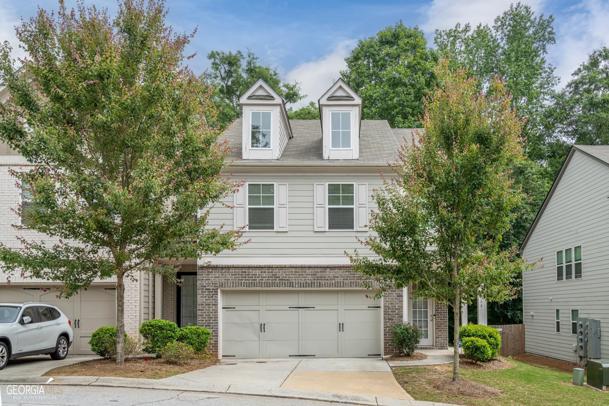 Welcome to Keystone Gates, a beautiful Gated community in Lithonia GA. This end unit Luxurious 2-story townhome is located in a Swim Community! Exceptional townhome has been kept up and offers an open floor-plan with tons of natural lighting! Walk into the fantastic entry that leads you straight into the family room with coffered ceilings and a gourmet kitchen which highlights a plenitude of cabinet space and an island, stainless steel appliances, ravishing granite countertops. The family room has built-in bookshelves, gas fireplace and columns that separate the dining area. Upstairs highlights a spacious loft, larger than usual owner's suite, his and hers isolated vanities and a separate shower. Appreciate that there is No carpet downstairs , the stairs and the loft area. Private fenced backyard with a patio perfect for relaxation and much more! 2 Car garage with additional driveway parking plus a guest parking area.