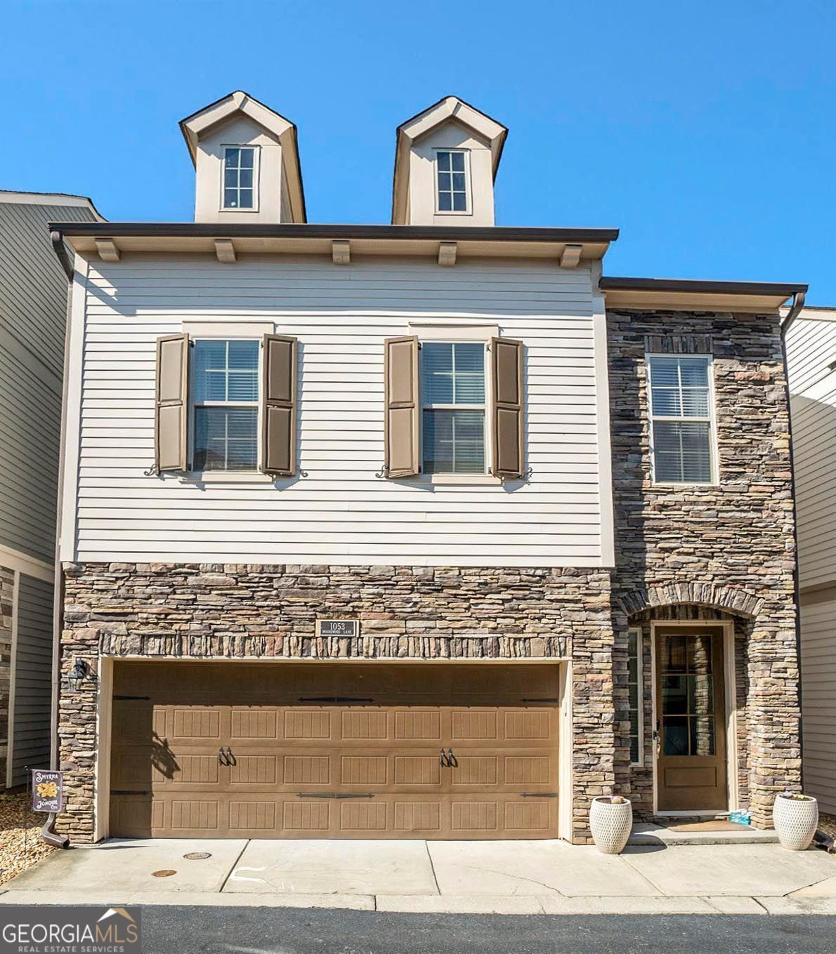 Step inside this bright and beautiful 4-bedroom, 3.5-bath home located in the sought-after Village of Belmont community. This open-concept design is filled with natural light and showcases modern finishes throughout. The gourmet kitchen features granite countertops, stainless steel appliances, and abundant cabinet space. On the second level, the spacious primary suite includes a spa-like bath with soaking tub, walk-in shower, and a very generous walk-in closet. Additional second floor bedrooms are perfect for guests or a home office. The third level includes an additional bedroom and bath, as well as a large bonus room perfect for your child's playroom, the man cave, craft room or an expansive workout room. An outdoor living space with a small private fenced patio has plenty of space for your outdoor sofa, chairs, patio umbrella and grill. Community amenities include pool and green spaces. Smyrna Elementary School is a 6 minute walk from your front door and Campbell Middle and Campbell High School are also within walking distance. This home is conveniently located near Truist Park and Smyrna Market Village, with many dining and shopping options very close by. Also easy access to I-285 and I-75.