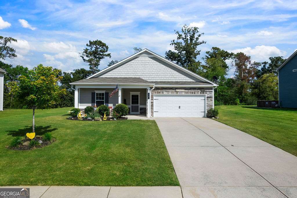 Welcome to this beautifully maintained 3-bedroom, 2-bathroom ranch in the sought-after Woody Farms subdivision of Adairsville, Georgia-a charming small town conveniently located between Cartersville and Calhoun, with quick access to I-75 for an easy commute to Atlanta or Chattanooga. This spacious 1,504 square foot home sits on a well-manicured 0.28-acre lot and offers a thoughtfully designed split-bedroom floor plan with fresh paint inside and out. Step through the private front entry into a welcoming foyer that leads to an open-concept living space featuring high ceilings and a seamless flow from the dining area to the family room. The kitchen includes solid surface countertops, a pantry, and a functional island that houses the sink and dishwasher, along with a small breakfast bar and a view into the family room-ideal for everyday living and casual entertaining. The owner's suite features a tray ceiling, walk-in closets, and double vanities, while the secondary bedrooms-carpeted for comfort-provide their own sense of privacy and space. Additional features include insulated windows, disappearing attic stairs, and a garage with built-in shelving that is both functional and impressively organized. Outdoors, enjoy a covered front porch, raised flower beds, a beautifully landscaped yard with peaceful rural views, and a back patio area perfect for relaxing near the cozy fire pit. This home blends modern convenience with country charm and is ready for you to move in and enjoy.