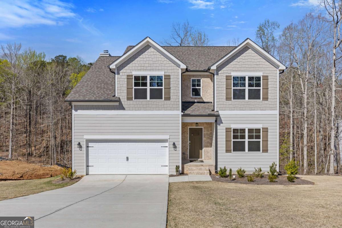 Welcome to the Sutton plan by Paran Homes, a move-in-ready home on a scenic half-acre lot with no HOA. This home features a full unfinished walk-out basement and a private, sodded backyard with irrigation, backing up to peaceful natural woods. Enjoy outdoor dining on the back deck or relax inside the open-concept main level, which includes a wood-burning fireplace, granite countertops, stainless steel appliances, a stylish tile backsplash, crown molding, and no carpet on the main floor. The layout includes a flex or dining space, eat-in kitchen, and spacious family room. Upstairs, the primary suite offers a tray ceiling, crown molding, and natural light. The spa-like bath features a frameless glass shower with dual shower heads, bench seating, tile flooring, a double vanity, and a large walk-in closet. Located near Burnt Hickory Park and only 3.5 miles from Downtown Dallas, this home offers both convenience and privacy. This is a new construction home. Photos and finishes are representative and may not reflect the actual home.