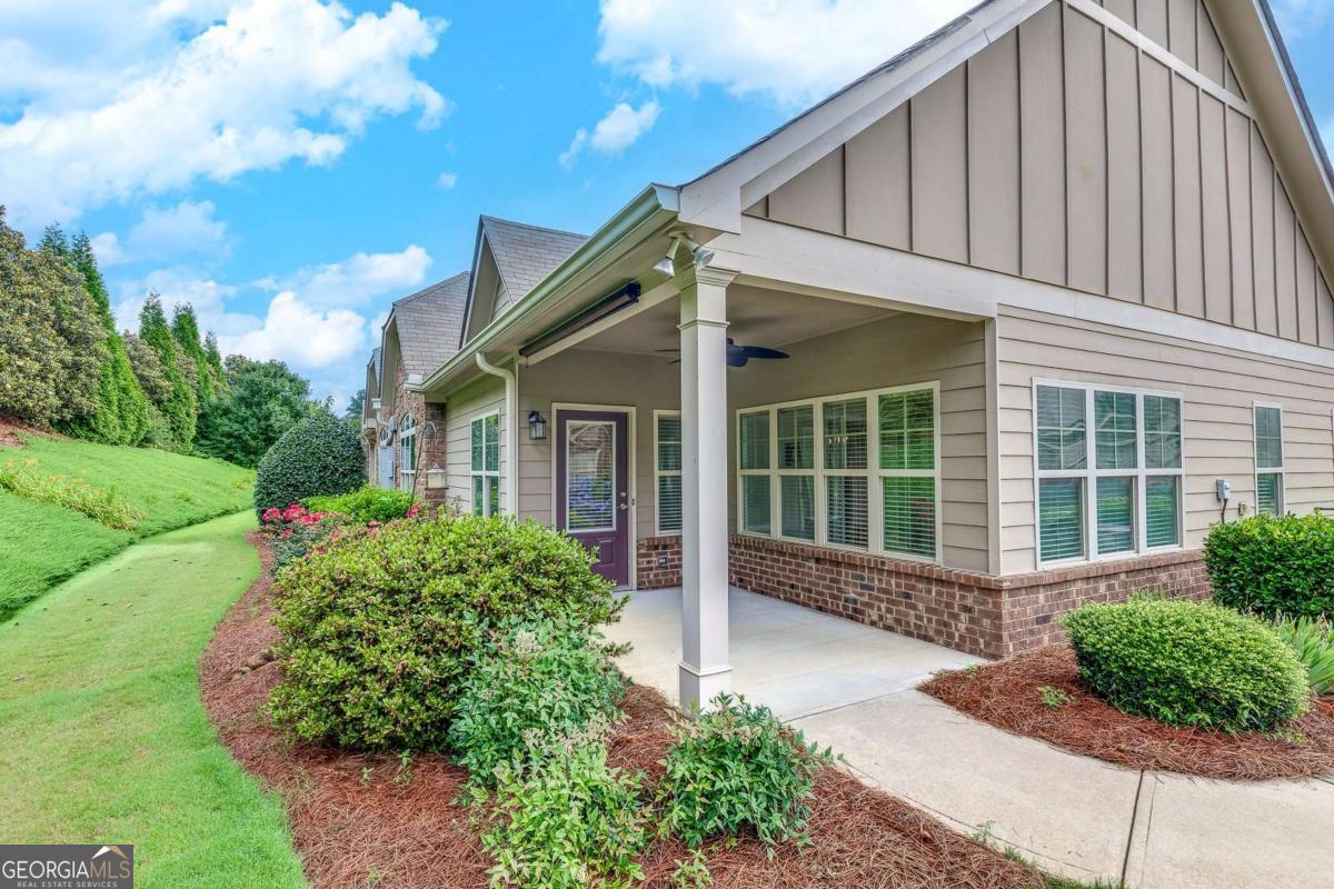 Welcome to this beautiful, move-in ready corner patio home nestled in the sought-after gated community of Arbor Ridge. This active adult neighborhood, consisting of just 56 homes, offers a welcoming lifestyle with amenities that include a clubhouse with an exercise room, meeting space, and a refreshing pool. The inviting covered front porch overlooks a private, landscaped area, setting the tone for the comfort and charm found throughout the home. Inside, you'll find a spacious living room featuring a cozy fireplace with gas logs, seamlessly connected to a sunroom with French doors that open to views of the beautifully maintained landscaping. The open-concept dining room flows into an eat-in kitchen complete with stained cabinetry, granite countertops, and all appliances included. A convenient laundry room, equipped with washer and dryer, adds to the home's thoughtful design. The primary suite is a peaceful retreat, highlighted by a double tray ceiling and an ensuite bath with a double vanity, separate shower, and walk-in closet. A generously sized guest bedroom offers an adjoining private bathroom, ensuring comfort and privacy for visitors. Upstairs, a versatile bonus room provides ideal flex space for a home office, hobby area, or additional guest accommodations. Enjoy the convenience of a two-car garage with a dedicated storage room, and take advantage of the low-maintenance lifestyle that gives you more time to enjoy the community's amenities and all the surrounding area has to offer.