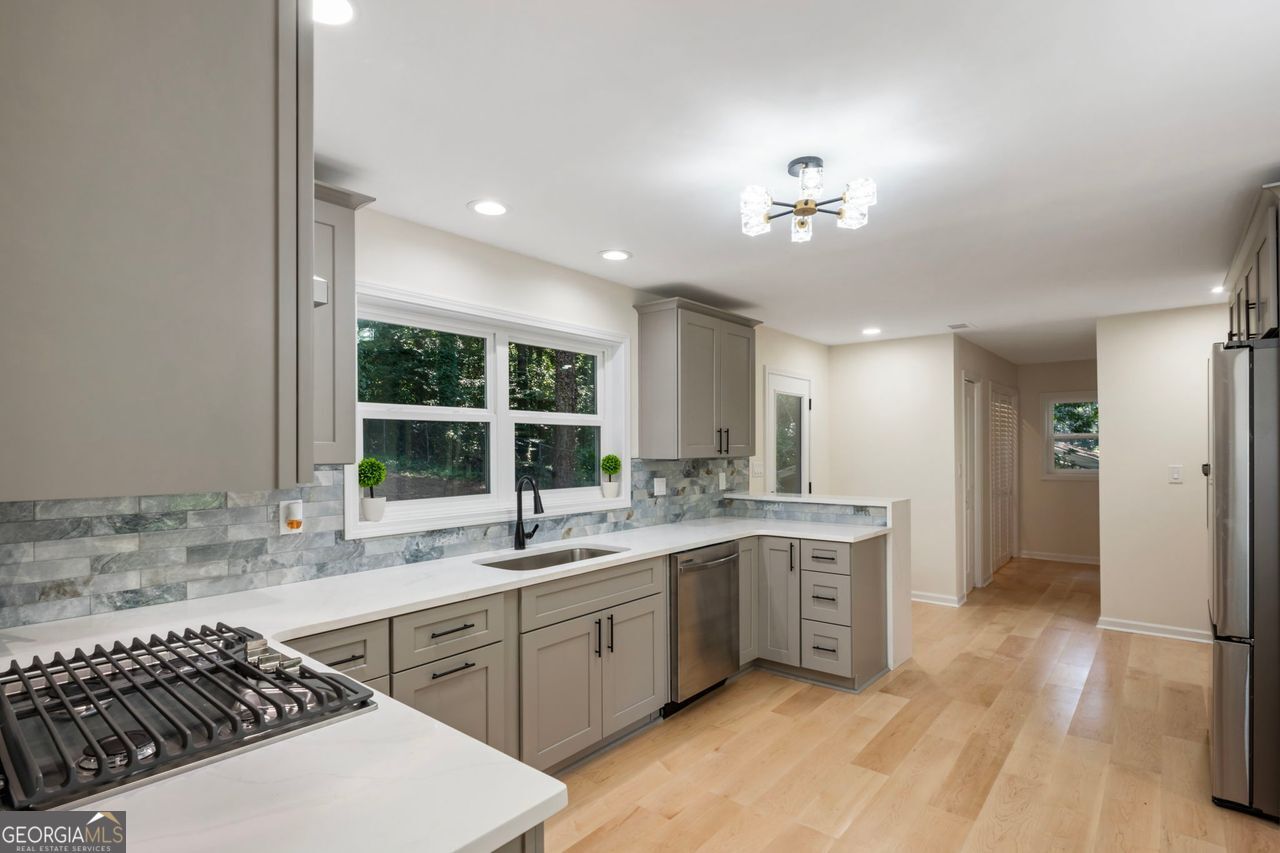 Fully Renovated Mid-Century Gem in Prime Atlanta Location - Ready to Move In! Welcome to 2431 Nancy Lane NE, a stunningly reimagined 4-bedroom, 3-bathroom brick ranch located in the highly sought-after Shallowford Heights neighborhood of Atlanta. Set on a spacious 0.33-acre lot, this home seamlessly blends timeless mid-century charm with top-to-bottom modern upgrades and designer finishes. Step inside to a bright open-concept layout featuring engineered hardwood floors, a cozy fireplace, and a chef-inspired kitchen outfitted with a large island, quartz countertops, brand-new soft-close cabinets, and all new stainless steel appliances, including a refrigerator, cooktop, double oven, and dishwasher. Whether you're entertaining or cooking a weeknight meal, this space is designed to impress. The luxurious primary suite offers a peaceful retreat with a spacious walk-in closet and a spa-style bathroom showcasing dual his-and-her showers, a center rainfall shower, modern LED lighting, and elegant designer tilework. All three full bathrooms have been fully remodeled with upscale finishes and thoughtful touches throughout. Notable Upgrades:* Brand-new Trane high-efficiency HVAC system * New roof and gutters * Fresh interior and exterior paint * Upgraded insulation * Energy-efficient new double-pane windows and doors * All new stainless steel appliances (refrigerator, cooktop, double oven, dishwasher) * New soft-close cabinetry throughout * Fully upgraded restrooms with modern tile, fixtures, and LED lighting * Engineered hardwood floors throughout. Enjoy the private, level backyard, ideal for outdoor entertaining, relaxing, or gardening. Perfectly located just minutes from Emory University, the CDC, CHOA, I-85, and top-rated restaurants, parks, and shopping destinations. Zoned for Hawthorne Elementary, Henderson Middle, and Lakeside High, with nearby access to The GLOBE Academy and optional Echo Ridge Swim & Tennis Club membership, this property offers a rare blend of location, and luxury. This move-in-ready masterpiece is the total package-schedule your showing today!