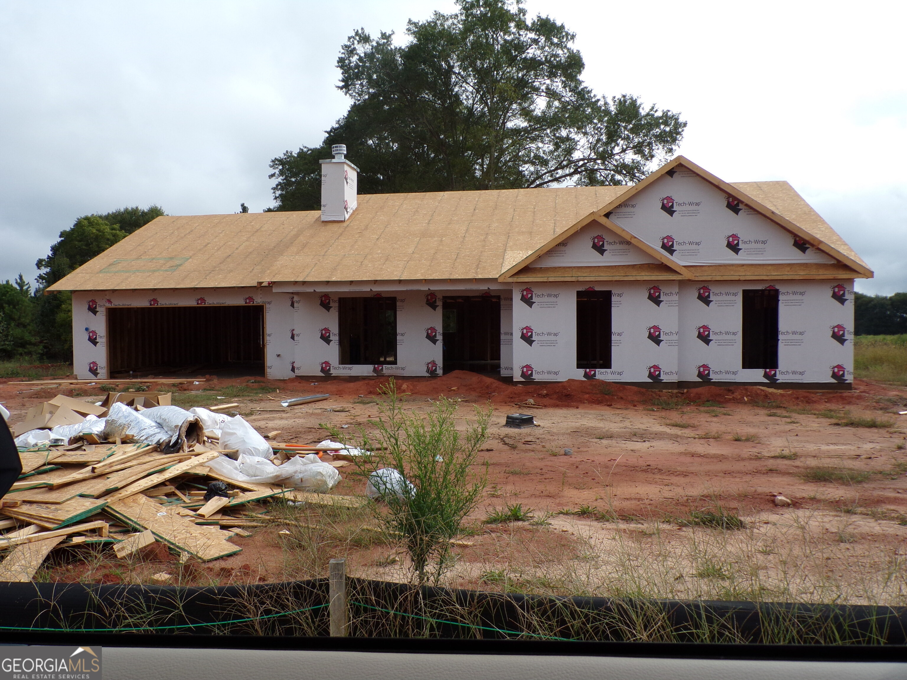 The Sarah floorplan - NEW CONSTRUCTION on large, wooded lots! Large Covered Back Porch! 4BR/3.0 BA is an Open Concept plan with Wood-Burning Fireplace in the Family room and Built-in shelving/cabinets on each side of fireplace. Granite countertops throughout. LVP flooring throughout. Kitchen has a Work Island and Pantry. Separate Dining area. Spacious Master Suite w/ Soaking Tub, Separate Shower & Separate His & Her Vanities! Easy access to Hwy 78 and Hwy 316 for commuters. 2-10 Builder Warranty. Builder's Incentive $4000 in closing costs with preferred lender. Photos and/or renderings are representative and not the actual property. Estimated completion October 2025. Buyer can still choose colors!