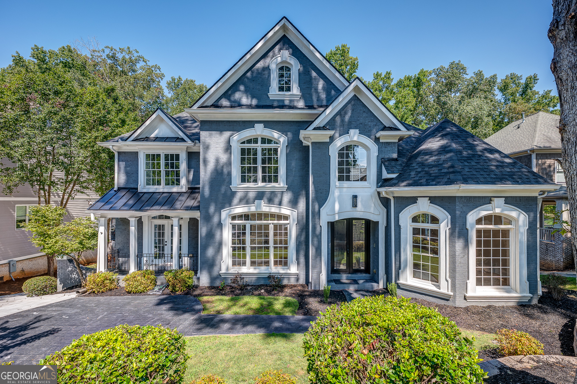 Located in highly sought after Lynnwood Park and within the Chamblee School District, this beautifully updated home offers luxury, function, and space. Featuring 2 kitchens, 2 laundry rooms, and a master suite on the main level, the home is designed for comfort and convenience. A dramatic 2-story foyer, refinished hardwood floors, and an automatic grocery elevator set this property apart. The fully renovated chef's kitchen includes Calacatta quartz waterfall countertops, custom cabinetry, a large island, vent hood, and butler's pantry. The primary suite on main boasts a spa-inspired bath with a curbless shower, standalone soaking tub, vaulted ceiling, lighted mirrors, and custom glass. Recent updates include: * New roof with 40-year architectural shingles * New HVAC systems (main, basement & 3rd floor) * Two 40-gallon gas water heaters * New sewer pump system * Updated electrical & lighting throughout * All new interior & exterior paint with epoxy-coated garage flooring Exterior features include a brand-new oversized deck, new landscaping with mature oak trees, updated exterior lighting, and new double-door entry. With 8 bedrooms, multiple living spaces, and thoughtful upgrades, this home offers flexibility for multi-generational living in one of Brookhaven's most desirable neighborhoods.
