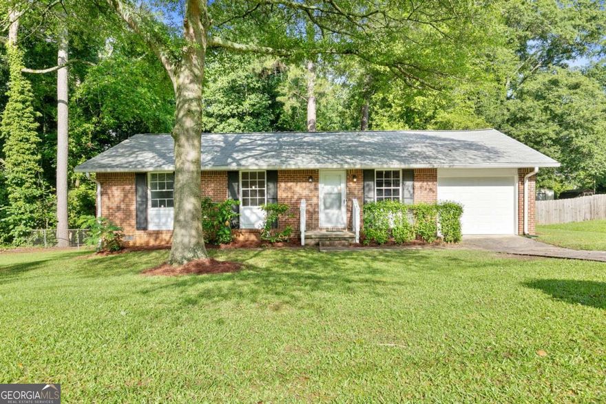 As we step into 6671 Gano Drive, let me show you why this one stands out. This 3-bedroom, 2-bathroom brick ranch has been meticulously maintained and thoughtfully updated, offering a blend of charm, comfort, and peace of mind that's hard to come by. Right away, you'll notice the curb appeal - that classic four-sided brick and the privacy of a tree-lined lot. Walk around back and you'll find a fully fenced yard and a quiet creek that runs along and behind the property - it's peaceful, calming, and gives the home a tucked-away feeling that's rare, especially with no HOA. Now step inside. One of the first things you'll see are the beautifully refinished hardwood floors, bringing warmth and character to every room. The natural light hits just right, especially with the fresh paint and updated lighting throughout. Every light fixture, every door handle, every detail has been chosen to create a clean, inviting space. The kitchen has been updated with gorgeous new granite countertops and is perfectly set up for both everyday living and hosting - whether you're prepping dinner or chatting with guests while you cook. Down the hall, there are two comfortable guest bedrooms, an updated guest bathroom, and the primary suite, which features its own private bath - both bathrooms have been updated with new tile work and modern finishes, along with durable vinyl flooring for a sleek, low-maintenance touch. The updates don't stop at what you can see. Behind the scenes, the home features a newly installed AC system, a newer roof, new garage door, added attic insulation, and a full moisture barrier in the crawlspace - all part of the effort to keep the home running efficiently and protected from top to bottom. A whole-home security system is already in place for added peace of mind. This home isn't just move-in ready - it's been loved and looked after, and it shows. And if you need to commute or travel, you're less than 20 minutes from both the Atlanta airport and downtown - so convenience is never a question. 6671 Gano Drive isn't just a house - it's the kind of place that feels like home from the moment you step inside. I'd love for you to experience it in person. Let's schedule your private tour and see if this is the one you've been waiting for.