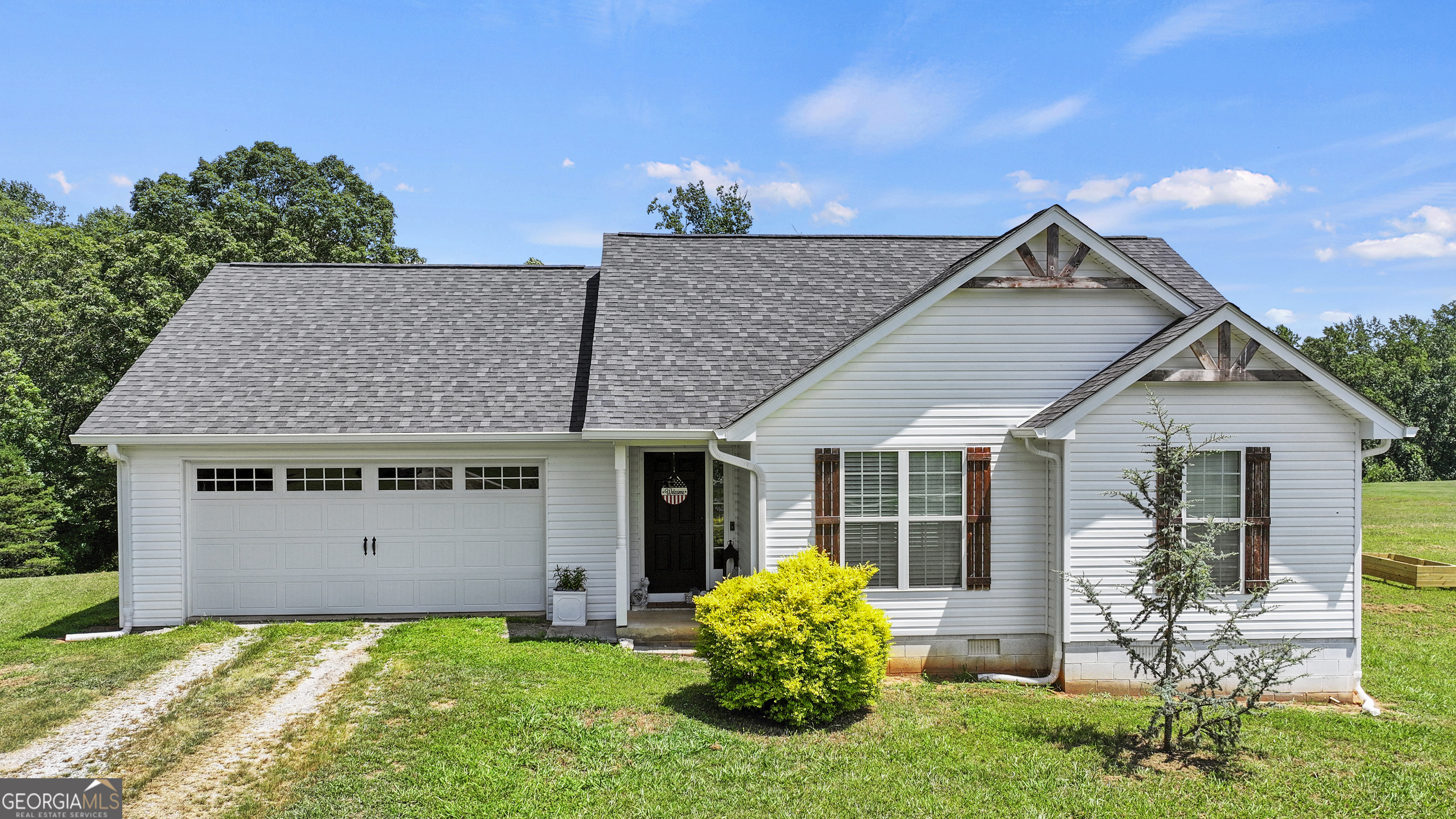 This well-maintained home sits on 3.3 private acres in Cleveland, GA, located in beautiful White County. Built in 2019, this 3-bedroom, 2-bathroom home offers a spacious and functional layout designed for comfort and privacy. The living room and dining area are open and perfect for entertaining family and friends. The kitchen features stainless steel appliances, all in excellent condition and very well cared for. The primary suite includes a large bedroom, a walk-in closet, and a private bathroom. The two additional bedrooms are generously sized with convenient access to the second bathroom and offer great closet space. A two-car garage provides ample room for vehicles and storage. Outside, the front and back yards offer incredible potential for outdoor living, gardening, or future expansion. Located in a quiet, private setting with no HOA, this property is ideal for anyone looking for modern living with room to grow. Schedule your showing today.