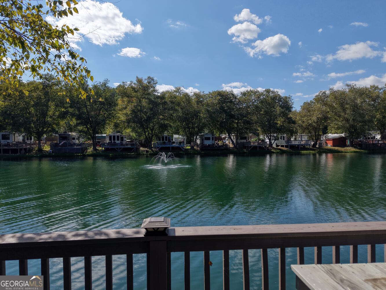 Discover the perfect blend of comfort, convenience, and natural beauty with this RV lot for sale in the highly sought-after Rivers Edge RV Park. Situated on a large pond this lot is perfect for both full-time and part-time living. The property features a large deck for your RV, and a connecting elevated platform deck where you can relax and take in the peaceful pond views or cast a line to fish right from your own private deck. A storage shed is already in place, ready to be customized into a cozy she shed, man cave, office or extra storage space. Shade trees provide a cool retreat during warm summer days. Rivers Edge RV Park is known for its welcoming community and prime location. Whether you enjoy golf cart rides, casual strolls, or friendly gatherings, you'll feel right at home. The community clubhouse offers great amenities including a laundry room, showers, and a spacious rocking chair porch overlooking the lake. The affordable HOA takes care of lawn maintenance, water, sewer, trash, and common areas, making life easy and stress-free. Outdoor enthusiasts will love being near Brasstown Bald (the highest mountain in Georgia), Vogel State Park, and stunning waterfalls like DeSoto Falls and Helton Creek Falls. Hiking trails, local farms with fresh U-Pick produce, and endless mountain adventures are just minutes away. This property is more than just a lot, it's a lifestyle. Bring your RV and start enjoying the mountain life you've been dreaming of.
