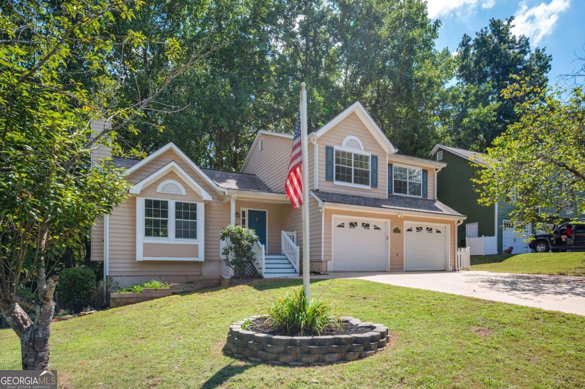 Welcome to this recently updated 4-bedroom, 2-bath home tucked away on a quiet cul-de-sac. The spacious family room features vaulted ceilings and a cozy gas fireplace, flowing seamlessly into the dining area for easy entertaining. The kitchen offers ample storage, quartz countertops, stainless steel appliances, and a sunny eat-in area. The primary suite includes trey ceilings and an en-suite bath with double vanity, soaking tub, and separate shower. The fully finished walk-out daylight basement provides additional living space, perfect for a media room, playroom, or home office. Thoughtful updates include new carpet, sustainable luxury vinyl plank flooring, fresh paint throughout, updated light fixtures, and a brand-new deck. Outdoor living is complete with a fenced private side yard, ideal for relaxing or pets. Conveniently located just minutes from Downtown Woodstock, Towne Lake shopping and dining, and Lake Allatoona, this home offers comfort, style, and a fantastic location.