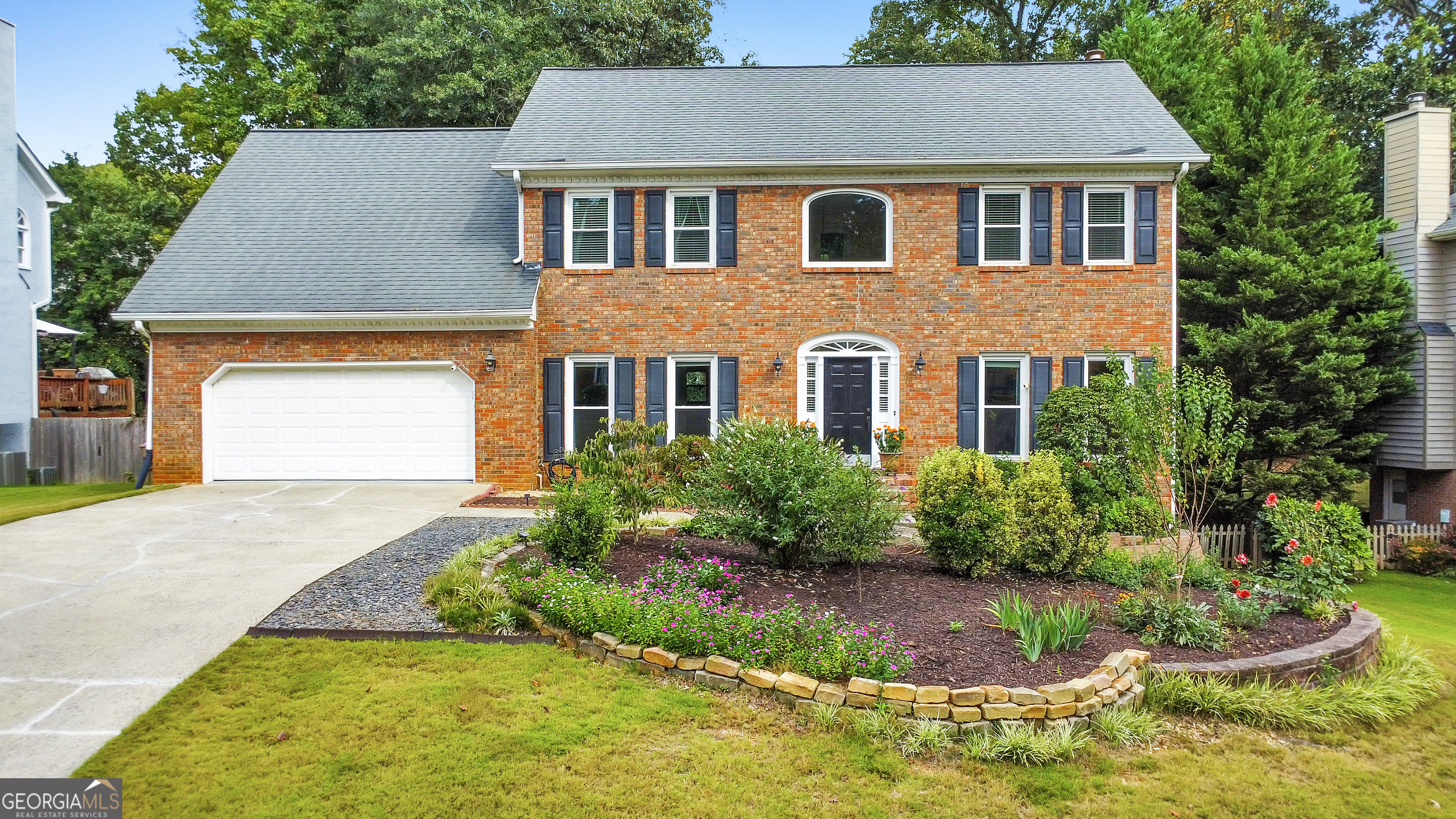 This timeless beauty blends elegance and comfort, offering the perfect place to call home! Step inside to a stunning 4 bed / 3.5 bath brick-front residence in the highly sought-after Pope High School district. A welcoming two-story foyer opens to hardwood floors flowing throughout the main level, complemented by updated windows with a lifetime warranty, fresh interior paint, and new carpet. The fireside family room, accented by bay windows, a wood-burning fireplace with gas starter, and a built-in wet bar, creates a warm gathering space. The elegant kitchen features granite countertops, an island for extra prep space, and updated appliances including a dishwasher, oven, and microwave. Upstairs, the oversized primary suite is a true retreat with its own sitting area, large walk-in closet, extra storage space, and a spa-like bath with a new tub and flooring. The hallway bath has also been upgraded with a new shower and bidet. Both bathrooms come with a lifetime warranty, offering peace of mind. The finished terrace level expands living space with hardwood floors, a granite wet bar, rec room, full bath, and ample storage. A versatile bonus room, currently set up as an office, features new carpet and could easily serve as an additional bedroom. Outdoor living is equally impressive, featuring a freshly painted exterior, refreshed deck and underdeck, covered patio, new fire pit, and a fully fenced backyard with a vegetable garden. Additional updates include HVAC inspection and repair, a roof inspection, added barn doors in the office, garage wire shelving, a basement keypad door lock, landscaping enhancements, power washing, and a termite bait system bond professionally maintained by North Fulton Pest Solutions. Don't miss the opportunity to make this exceptional property your own!
