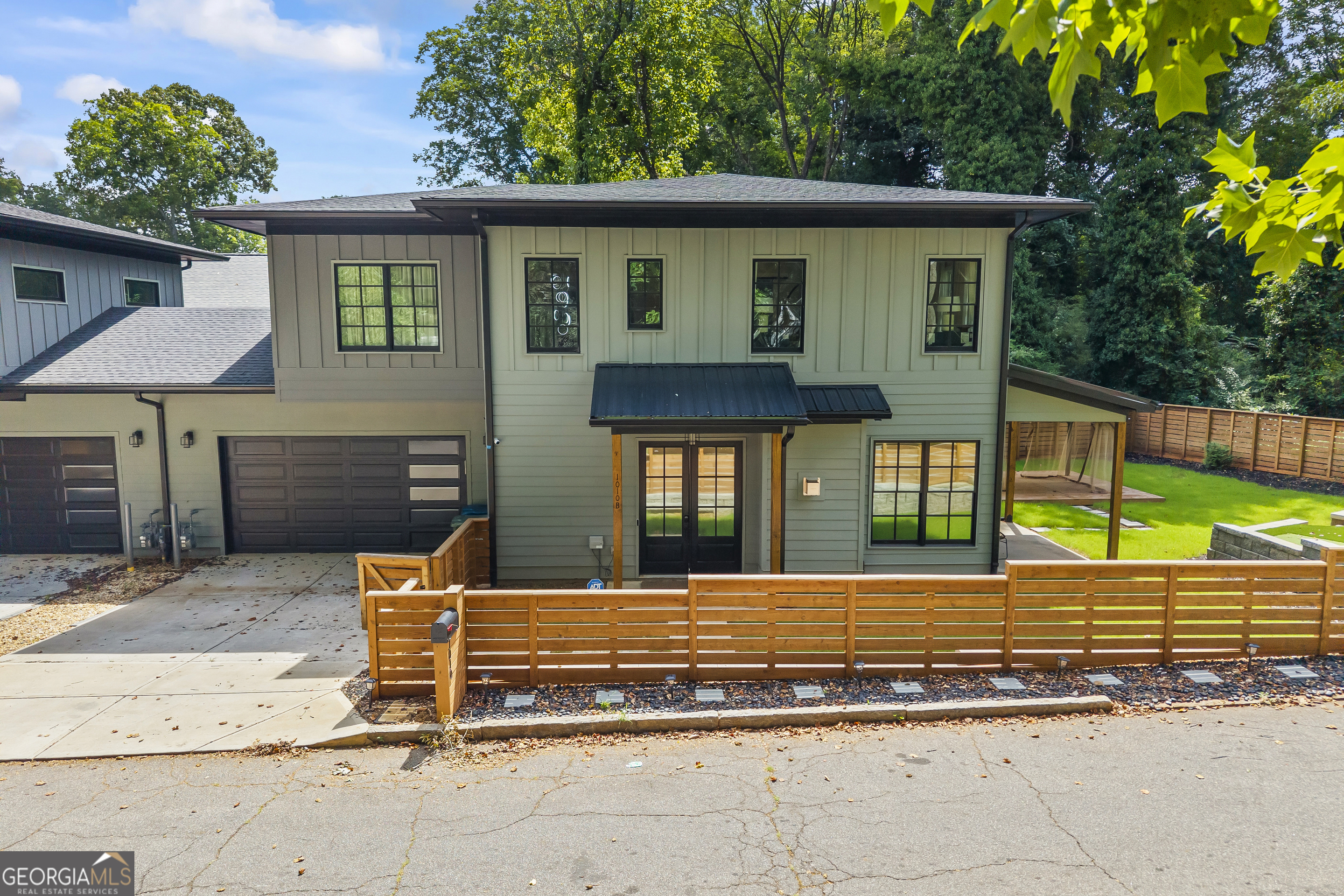 Luxury Living Along the Westside BeltLine Experience elevated living in this exquisitely designed 3-bedroom, 2.5-bath residence located in the vibrant heart of Oakland City, just steps from the Westside BeltLine. Thoughtfully crafted with timeless elegance and modern sensibilities, this home offers a truly sophisticated lifestyle. Soaring 10-foot ceilings, rich hardwood flooring, and expansive oversized windows create a sun-drenched ambiance throughout the home. The living room serves as a refined centerpiece, anchored by an architecturally striking fireplace feature wall, a bold yet elegant statement of design. The gourmet kitchen is a culinary showcase, featuring premium stainless steel appliances, a quartz waterfall island that commands attention, and floor-to-ceiling black gloss cabinetry that exudes contemporary refinement. Ideal for both intimate dinners and grand entertaining, this space is designed to impress. Upstairs, the primary suite is a serene retreat. A custom walk-in closet and dressing room complement the spa-inspired bath, complete with an oversized glass shower and a sculptural free-standing soaking tub the epitome of indulgence. Positioned on a desirable corner lot, this townhome lives like a single-family estate, with only one shared garage wall. A private, fully fenced yard invites play and relaxation, while a two-car garage, and no shared driveway add exceptional convenience. The backyard comes fully equipped with a putting and chipping green, a gazebo and plush greenery for privacy and enjoyment. Located moments from Westside Atlanta BeltLine, Lee + White, Centennial Yards, and Mercedes-Benz Stadium, this home blends urban connectivity with the tranquility of upscale residential living. This is not just a residence, it is a lifestyle. Welcome to luxury redefined in Oakland City.