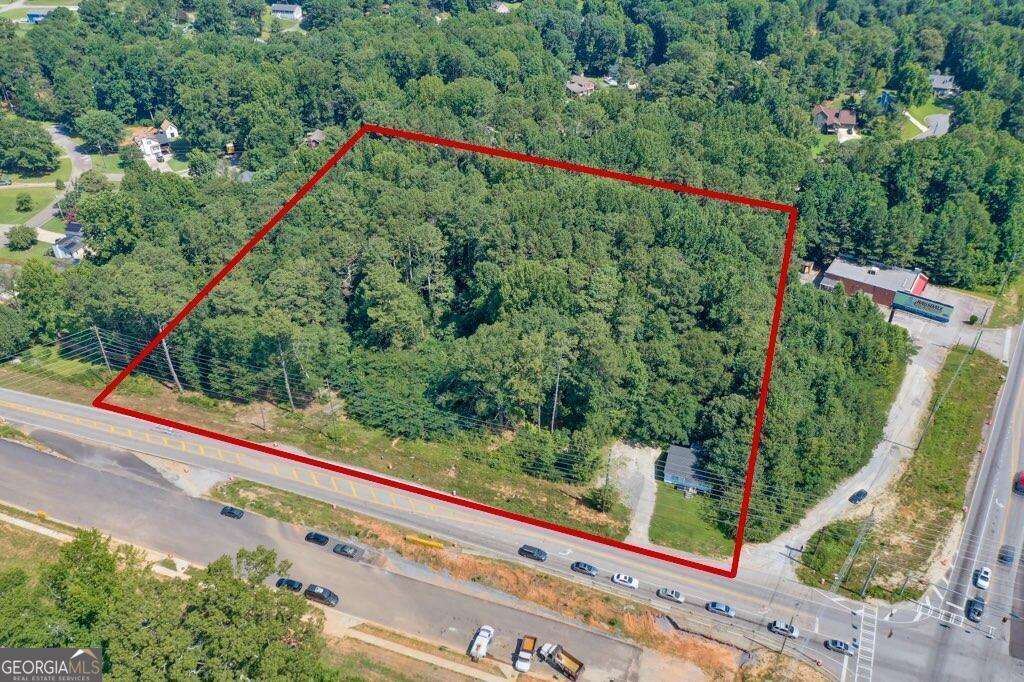 Property is near major intersection in one of the fastest growing counties. Excellent road frontage. 5.86 +/- Zoned B1, Great location for medical/office building, small grocery store/fuel, auto service, so many options. Scheduled to be 4 lane that goes to Douglasville, Macland Road goes to I75 near Truist Park. Close to Paulding/Cobb Line, Hospital. Great Opportunity!
