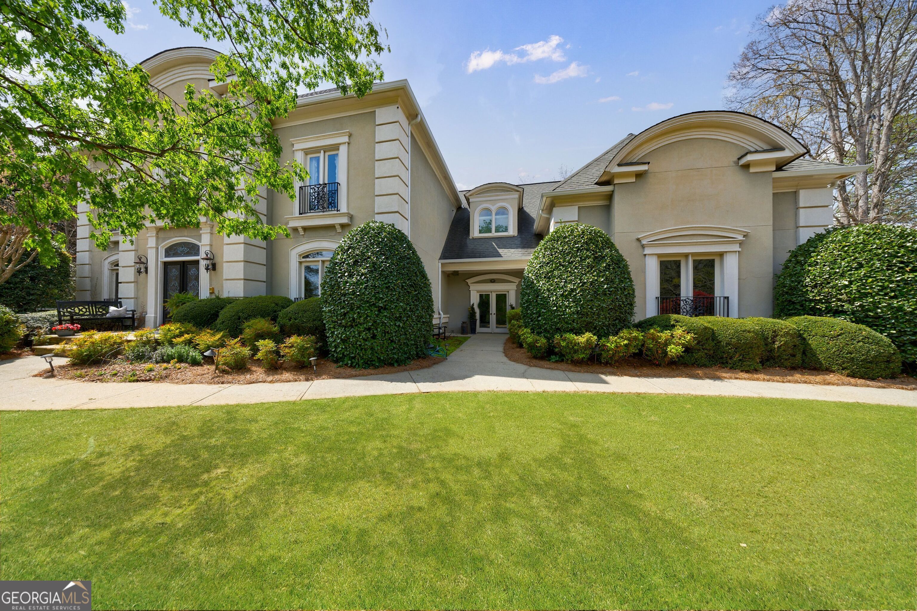 Discover this exceptional estate home in the prestigious COUNTRY CLUB of the SOUTH, offering a luxurious walkout pool and spa directly from the main level. The secluded backyard oasis features a waterfall spillover from the elevated hot tub spa, ample green space for outdoor games, and a charming gazebo cabana perfect for shaded relaxation and outdoor entertainment. The pool surround features blue stone slate creating beautiful setting. Upon entering through the elegant French doors, you'll be welcomed by an entry foyer with a striking central staircase. The formal living room seamlessly flows into the expansive keeping room featuring a fireplace flanked by built-in bookcases, creating a perfect space for entertaining. The banquet-sized dining room adjoins the chef's kitchen, which boasts a 48-inch gas range, stainless steel appliances, a center island, and a generous breakfast bar. The sunlit breakfast room and keeping room overlook the beautiful pool area. A thoughtfully designed rear foyer provides access to the four-car garage, a spacious mudroom, a casual powder room, and a laundry room with a utility sink. This area also offers easy access to the backyard for convenient poolside entertaining. The upper-level primary suite is a true retreat, featuring a sitting area with a cozy fireplace, a wall of windows, and an updated spa-like bath with a stand-alone soaking tub. The suite includes a massive flex space room, two independent walk-in closets, and a third walk-in closet complete with a built-in desk. Three additional en-suite bedrooms are located on the upper level, each with its own updated bath and ample closet space. The finished terrace level offers even more space for relaxation and entertainment with a wet bar, family room, game area, and exercise room. A private terrace-level bedroom with a full bath and French door access to a covered patio completes the space. Every corner of this home offers generous living areas designed for both comfort and luxury. Enjoy the security and prestige of living in a gated community with optional Country Club membership, providing access to premier golf, tennis, and resort-style amenities. Don't miss this extraordinary opportunity to own a home that combines elegance, space, and an unbeatable location!