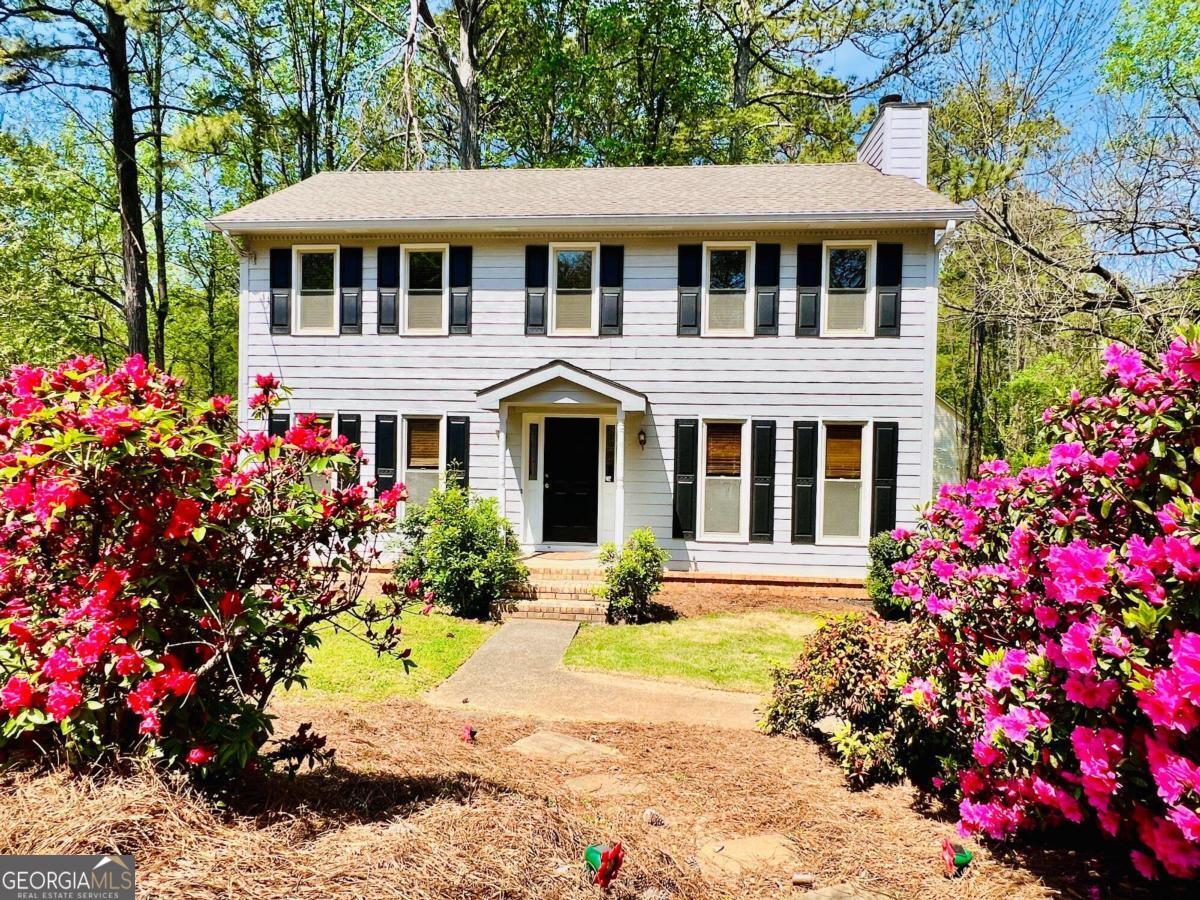 Introducing a charming colonial-style home in Marietta, perfectly situated for convenience and comfort. This move-in-ready property boasts three bedrooms, two and a half baths, and a partial basement. With a two-car garage and an additional two-car carport, parking will never be an issue.     Nestled in a great location, this home offers easy access to shopping, dining, and entertainment options. Close proximity to Kennesaw State University, I-75, and I-575 ensures convenient commuting and access to amenities. Don't miss out on this opportunity to own a well-appointed home in a sought-after area.