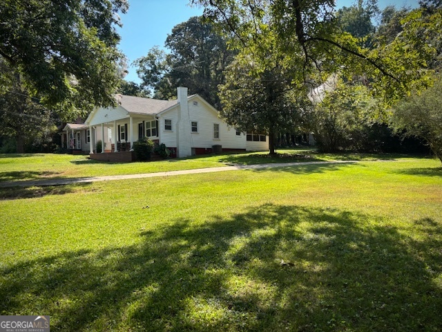 BEAUTIFULLY RENOVATED HOME PERFECTLY BLENDS MODERN UPDATES WITH 1940'S CHARACTER AND CHARM SITUATED ON A DOUBLE CITY LOT, COVERED FRONT PORCH, FAMILY ROOM WITH FIREPLACE, ROOF 3 YEARS, ELECTRICAL & PLUMBING UPDATED 2025, ALL NEW LVP FLOORING THROUGHOUT (NO CARPET), ALL NEW INTERIOR LIGHTING AND INTERIOR PAINT, ALL NEW INTERIOR DOORS AND HARDWARE, GORGEOUS COUNTRY KITCHEN WITH BREAKFAST BAR ADJOINING HUGE DINING, DEN & FAMILY ROOM PERFECT FOR EVERYDAY DINNERS OR BIG FAMILY GATHERINGS, KITCHEN FEATURES, NEW MODERN BASE CABINETS WITH SPARKLING WHITE CORIAN COUNTER TOPS, NEW APPLIANCES, AND PANTRY, VINTAGE PINK TILE BATH COMPLETELY COMPLIMENTS THE TRUE CHARM THIS HOME, EXTERIOR FEATURES 10X20 OUTBUILDING FOR STORAGE (ON A POURED SLAB) WITH NEW ROOF, DOUBLE SHADED LOTS, QUIET CULDESAC STREET, #THISISHOME