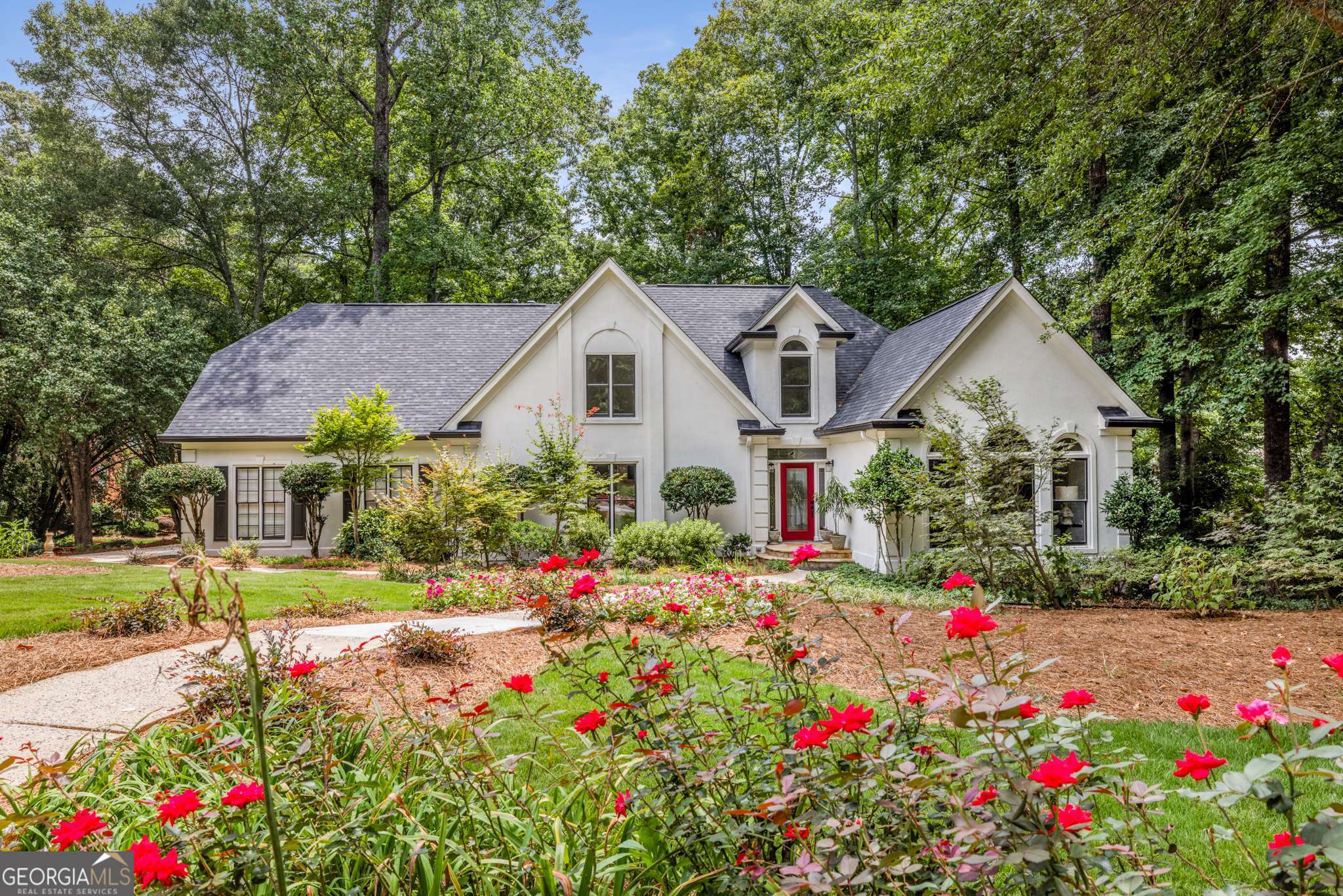 Welcome to this beautifully renovated one-owner home in the heart of Alpharetta! Ideally located just minutes from Wills Park, Avalon, and vibrant downtown Alpharetta, this move-in ready gem offers modern updates, a private backyard oasis with a POOL, and access to top-rated schools. Step inside to discover all-NEW FLOORING, including durable luxury vinyl plank on the main level, tiled baths, and plush carpet upstairs, plus fresh interior and exterior paint, and updated light and plumbing fixtures. The renovated kitchen features refreshed cabinetry with soft-close doors and drawers, a PANTRY, new stainless steel GE appliance package, and an open view to the spacious great room with a fireplace. The oversized primary suite is on the main level and features a custom walk-in closet, and a spa-like bath with separate vanities, a soaking tub, and frameless glass shower. A finished basement provides direct access to the pool deck and is perfect for entertaining, with a bar, resurfaced pool table, bedroom and full bath, ideal for guests or a private retreat. Outdoors, enjoy your newly updated deck, professionally landscaped grounds, a gazebo, and a private in-ground pool with a striking new liner and Trex decking - the perfect setting for summer relaxation and gatherings. Additional highlights include a NEW ROOF, newer HVAC systems (2023 & 2025), new electrical panel, a nest smoke and carbon monoxide system, and a universal Tesla EV charger in the 3-car garage. Don't miss this opportunity to own a thoughtfully upgraded home in one of Alpharetta's most sought-after areas!