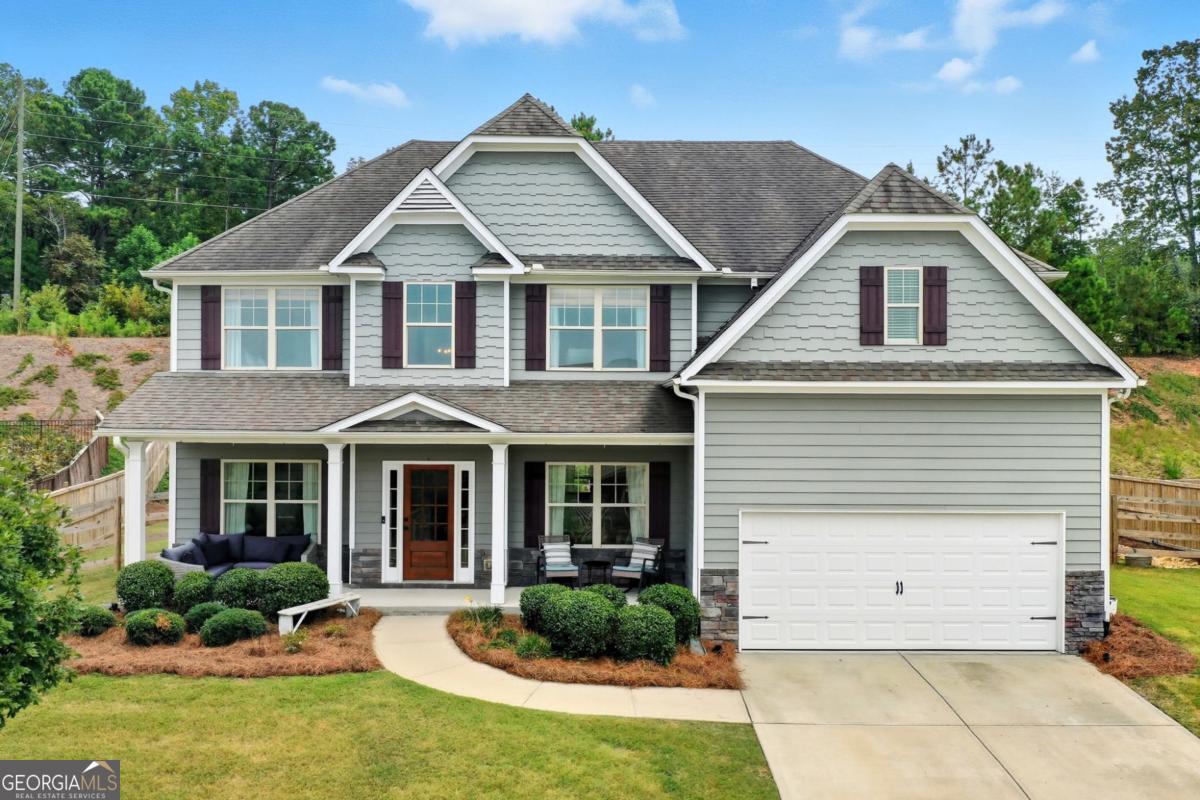 Move-in READY!!! This five bedroom home is located in The Manor at BridgeMill. You will love the open floor plan, private yard and OFFICE! Enjoy mountain views from the covered front porch of this well-maintained home built in 2014. Recent updates include a newer AC system, new appliances, new interior paint, full-house water filtration system, and a remodeled garage for added functionality. The home offers a spacious layout with five bedrooms and three full baths. The master suite features a remodeled bathroom and a large walk-in closet with a beautiful sitting area. . The kitchen provides ample cabinetry and workspace and a walk-n pantry with a view to the family room. Outdoor highlights include an extended patio, private backyard, and new retaining wall, ideal for relaxing or entertaining. Located in a convenient Canton community close to schools, shopping, dining, and major highways, this property combines comfort, updates, and a great setting. Easy access to GA Peach Pass(Express lanes), Northside Cherokee Hospital and is in the Cherokee High school district(slated to open next fall and is state of the art).