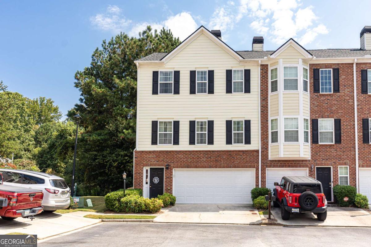 Welcome to this beautifully maintained three-level end-unit townhome in the highly desirable Fairview Park community of Sugar Hill-complete with swim/tennis amenities and unbeatable location. Nestled off a cul-de-sac with ample guest parking, this home enjoys one of the best spots in the neighborhood, featuring a side yard and private wooded backdrop. The upcoming Sugar Hill Greenway will run right behind the community, and the public Sugar Hill Golf Club is just steps away. Inside, you'll find thoughtful updates throughout: all-new LVP flooring, new quartz countertops, a brand-new deck, new roof and new hot water heater. The kitchen has been opened up with a bar seating area and flows seamlessly into the dining room and light filled, spacious living area with a cozy gas starter, wood-burning fireplace. A pantry, built-ins, and abundant closet space-including a walk-in primary closet-add function to the style. Upstairs, the primary suite boasts a dual vanity and the generous secondary bedroom with built-in closets provides flexibility. The terrace level offers a large bedroom with full bath and walkout access to the backyard-perfect for guests, a home office, or recreation space. Enjoy life in a quiet, welcoming community with resurfaced tennis courts, pool, and low HOA dues ($220/month, including water, sewer, landscaping, pool, and tennis). Conveniently located just minutes from Lake Lanier, downtown Sugar Hill, Suwanee Town Center, shopping, dining, and top-rated schools, this home offers both comfort and lifestyle in one of the hottest markets around. Don't miss your chance to make this home your own!