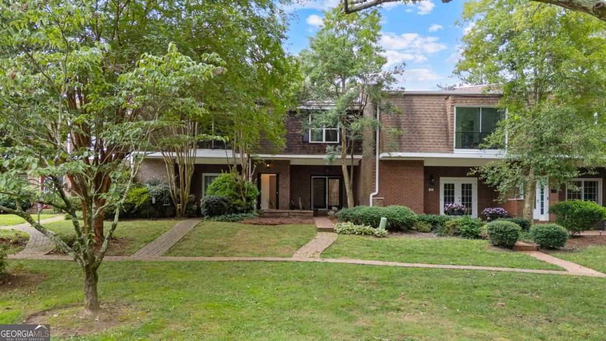 WELCOME HOME! Cutest townhouse ever right off Whitlock 3 minutes to Marietta Square! As you enter the light filled living space you'll notice the French doors to your front patio, a foyer area, and a historic fireplace with new vintage tile! All of downstairs features new wood tile! Kitchen features all new quartz countertops, stainless steel appliances, new cabinets, and island overhaul perfect for breakfast stools overlooking into the dining space! First floor also features a half bathroom perfect for guests, walk in laundry room, two storage closets, mud room area with hooks, and a bonus room perfect for a office/playroom/work out space! As you go upstairs you'll again notice the great light this unit brings in! two greatly sized bedrooms and hallway bathroom with new floor tile! Master suite includes real hardwood floors, walk in closet, and bonus space perfect for an office/reading nook/workout space! Master bathroom has been completely redone with walk in shower, new cabinets, quartz countertops, and new hardware! Two car garage on main level makes carrying in groceries so easy! This unit overlooks the courtyard and green space giving you tons of privacy! Whole house has been updated throughout with new paint, new wood tile flooring on main level and real hardwoods upstairs, new HVAC, new appliances, new cabinets, new bathrooms, new kitchen, new hardware, and exterior has been pressure washed! Coveted Burress Elementary, Marietta Middle, and Marietta High!