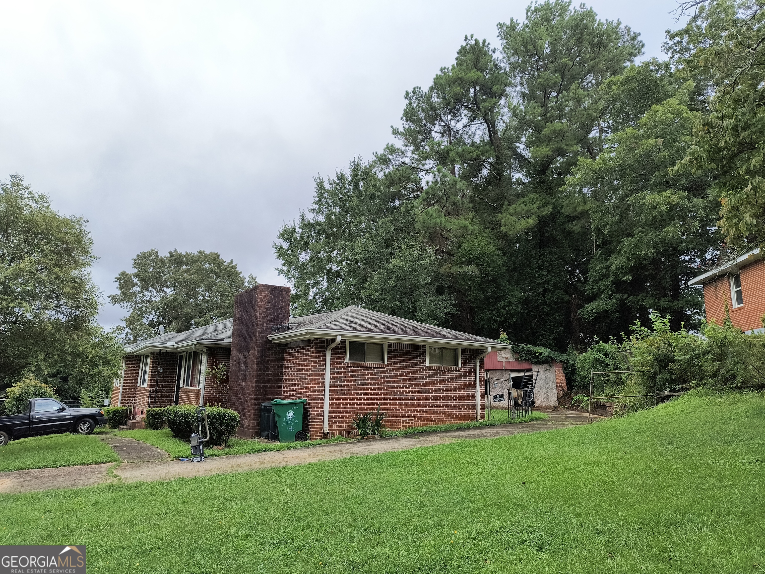 Calling all investors, this seller has a beautiful 4-sided brick home with a 2-car detached garage on a corner lot with a private fenced backyard, located near East Lake Golf Club. This home features solid hardwood floors, updated electrical box, a new water heater, roof only 8 yrs old with new gutters, has a huge den with a fireplace, a separate dining room & living room. The home just needs some tlc & updating. Text Taylor for an appt today @ 706-389-4419 or go thru showing time, no blind offers! Disclosures are in the associated docs tab