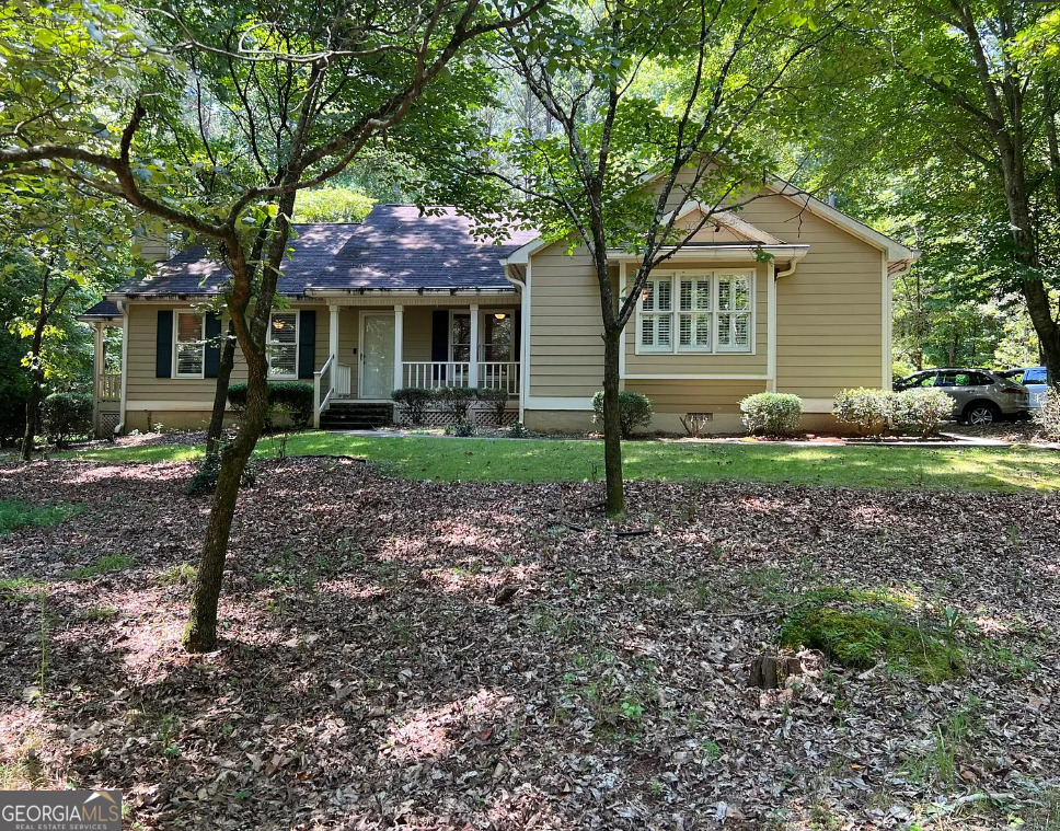 Long Driveway approaches this Pretty Front Porch Style Ranch on a secluded wooded homesite in Popular & Convenient The Landings Lake Neighborhood near Peachtree City & Trilith. Welcoming foyer opens into Spacious Great Room featuring Beautiful Built-in Bookcases, Brick Fireplace & door to a Dramatic Covered Side Porch overlooking Natural Backyard, great for sipping coffee & listening to the birds. Separate Formal Dining Room with French Doors also leading to the Side Porch. Cheerful Kitchen with White Appliances, Refrigerator, Bright Breakfast Room leading to a Mud Room & Garage. Rear Deck for Grilling. Elegant Primary Bedroom & 2 Additional Spacious Bedrooms, 2 Tiled Baths boasting Deep Soaking Tub, Walk-in Tiled Shower with Rain Showerhead and Skylight. Other features include Gleaming Hardwood Floors, Plush Carpeting, Plantation Shutters, Workbench in Garage. Two Car Garage with One Door. Great Opportunity to enjoy nature and yet so close to shopping & restaurants. Privacy & Easy Living so close to everything. Golf Cart Path Access to Peachtree City. See additional info on Qualifying in Private Remarks.