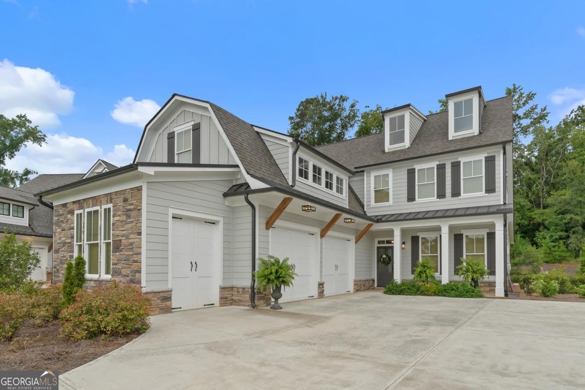 101 Wingspan Way with its lake access offers a beautiful craftsman-meets-modern farmhouse tucked inside the desired gated community of Cuscowilla on Lake Oconee. Built in 2021, this 4-bedroom, 3.5-bath home offers approximately 2,753 sq ft of thoughtfully designed living space, plus a spacious 3-car garage-perfect for vehicles, a golf cart, or all your lake toys. Step Inside You're greeted by rich hardwood floors, high ceilings, and an inviting open-concept living area anchored by a cozy gas fireplace. The gourmet kitchen is a cooks dream, featuring stainless steel appliances, quartz countertops, a large gas range, a huge walk in pantry, tons cabinets, and gorgeous lighting. Main-Level Retreat The primary suite is a true sanctuary, complete with a spa-like en-suite bath boasting dual vanities, an oversized walk-in shower, and direct access to the laundry room for ultimate convenience with a large walk-in closet. Upstairs Comfort & Flexibility The second level includes a large bedroom/bonus room with a full bath-perfect for a game room, media space, or private guest suite-plus two additional bedrooms connected by a Jack-and-Jill bath. Outdoor Living at Its Best Enjoy year-round outdoor living on the covered screened-in porch with a stone fireplace-perfect for crisp evenings or lazy afternoons. Experience the best of lake living and modern comfort in one of Lake Oconee's most sought-after communities. You will enjoy the easy access to the docks and big water views from private shared access docks in Eagles Rest.
