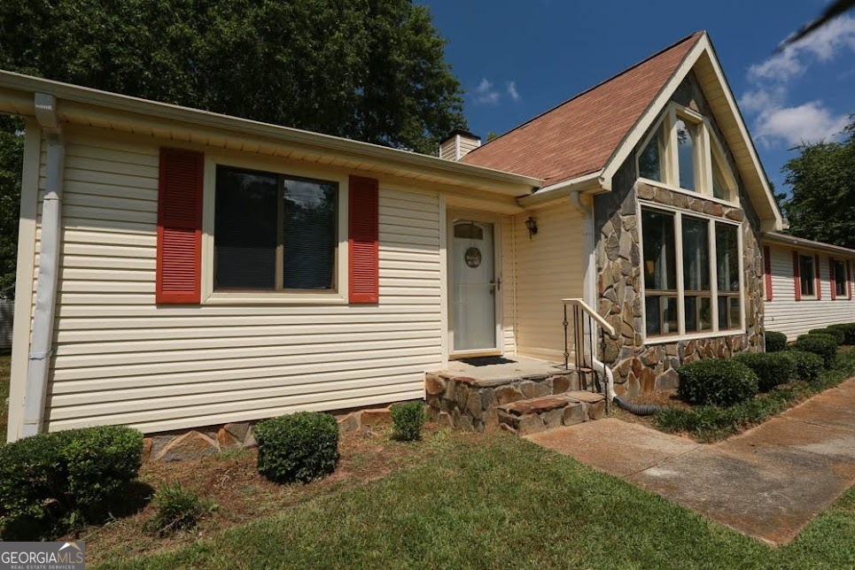 Perfect OPPORTUNITY is knocking! NO STEPS ranch home sitting on a HUGE LEVEL corner lot conveniently located in a quiet, established neighborhood in west GA with NO HOA! The high ceilings with WOODEN BEAMS, with a FIREPLACE that is sure to grab your attention in this open space! NEW flooring in foyer and kitchen, with carpet in spectacular condition! All this home needs is a little paint and imagination to make this lovely 3-bed, 2-bath home your own! Plenty of storage throughout this home with a large walk-in closet in the owner's suite. A back deck with a gas grill expands the backside of the home for all your entertaining desires or simply enjoying nature. Don't forget the OPTIONAL pool association! This is the only neighborhood in West GA with an optional pool and green space for you and your guests during the summer months! Schedule your showing today! **Some photos have been virtually staged**