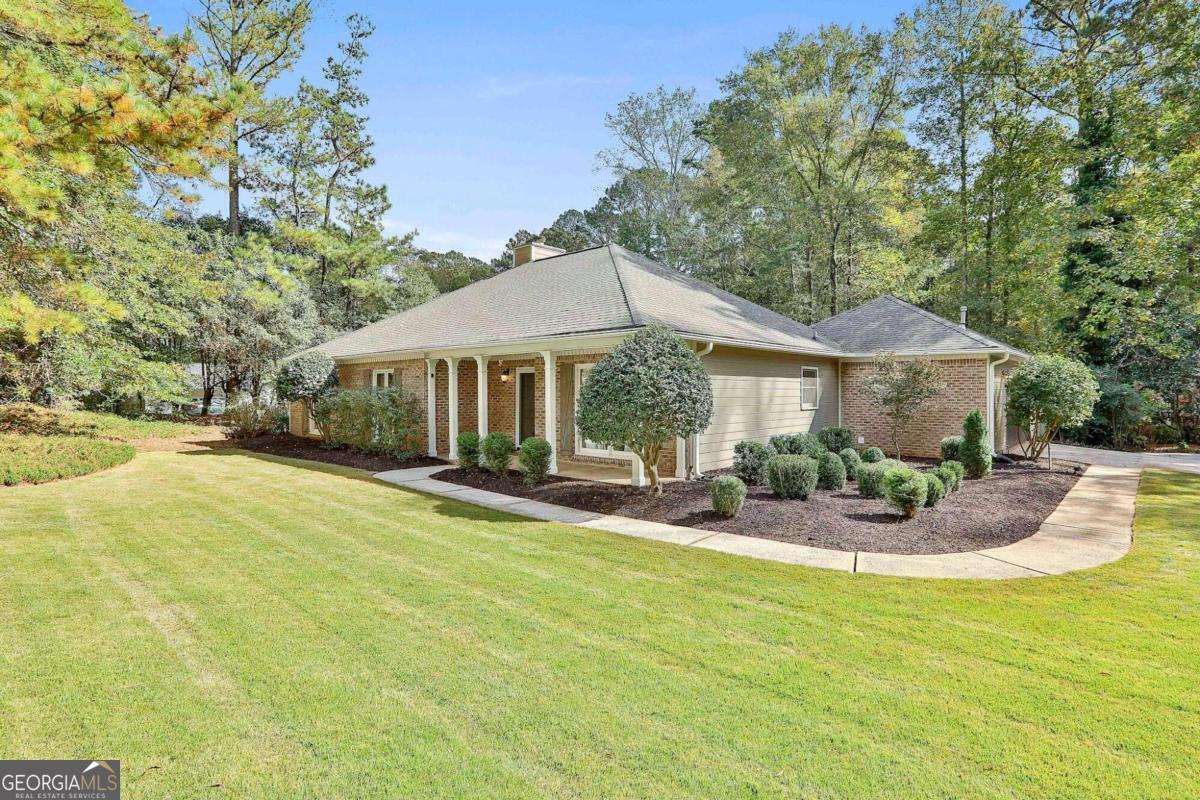 Welcome to your dream home in North Peachtree City! This true ranch-style property features 4 bedrooms, 2 baths, and an inviting floor-plan filled with character. Enjoy a modern, updated kitchen with silestone counters, subway tile backsplash and newer stainless appliances. The spacious living room highlights a beautiful brick fireplace and ample windows just perfect for gatherings. The large formal dining room provides an elegant space for entertaining while the owner's suite is a true retreat to escape to. With a remodeled master bath featuring a freestanding soaker tub, tile shower, and tile flooring this oversized room is sure to please. Recent upgrades include a new roof in 2018, a new water heater in 2021, and a new HVAC system in Fall of 2022. The air ducts have been professionally cleaned in September 2023. The Italian porcelain wood-like flooring, brand new carpet, and fresh interior paint throughout add to the allure of this home. A stunning outdoor space features an in-ground saltwater pool, updated in 2022 with a new pump, salt system, filtration cell, and timing system. Simply a perfect place for relaxation and recreation. A massive Trex deck with 16' Sunbrella Awning provides a great outdoor entertaining area. The property also features a fenced yard, attached garage, and an outbuilding for extra storage. Conveniently located in North Peachtree City, this home is close to shopping, parks, golf cart paths, easy interstate access to Atlanta, and Pinewood Studios. Don't miss out on this fantastic opportunity to make this your forever home! ** 2022 Advanced EV Golf cart comes with the home with full price offer **