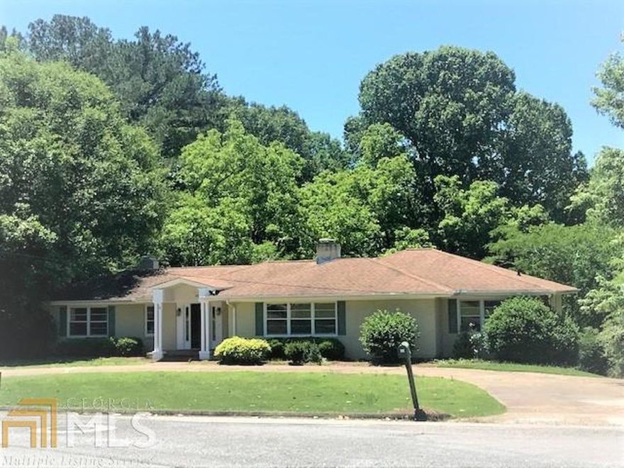 Large brick home with over 4,000 sq. ft. of living space.  4-5 bedrooms/3 baths. Beautiful kitchen with granite, custom cabinets ceramic tile and all stainless appliances.  Family room with over-sized gas fireplace/built-ins.  Lots of recessed lighting throughout.  Enormous dining room that will seat a multitude of guests inside while you have access to a large deck for outdoor entertainment.  Nice circular drive to your front door with a lower garage and extra  parking pad for many at the rear.