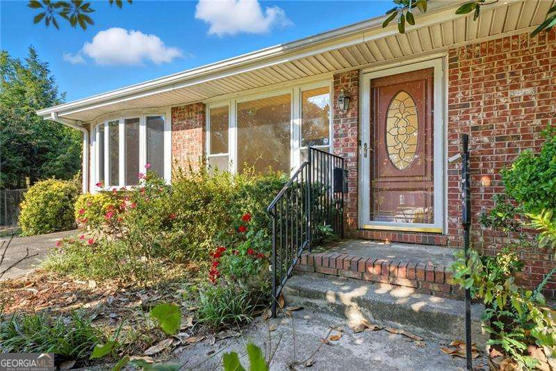 Vintage Charm Meets Everyday Comfort in Jonesboro. Step back in time but with all the right updates when you walk into this classic 1968 four-sided brick ranch. This home is full of character and charm, offering the kind of warmth you just don't find in today's builds. Inside, you will love the parquet hardwood floors that set the tone with vintage style. The spacious family room is perfect for movie nights or gatherings, while the separate dining room with a dry bar nook sets the scene for dinner parties or Sunday suppers. With three bedrooms and one and a half baths, the layout is practical yet cozy. Step out back and you will find a large deck overlooking your private backyard, ideal for summer cookouts or morning coffee. With the school right across the street, you can walk your children to school and enjoy the convenience of being only minutes from downtown Jonesboro. This home is for the buyer who craves character over cookie-cutter, a place with soul, stories, and timeless appeal. Come fall in love with its vintage vibe and start your next chapter here.