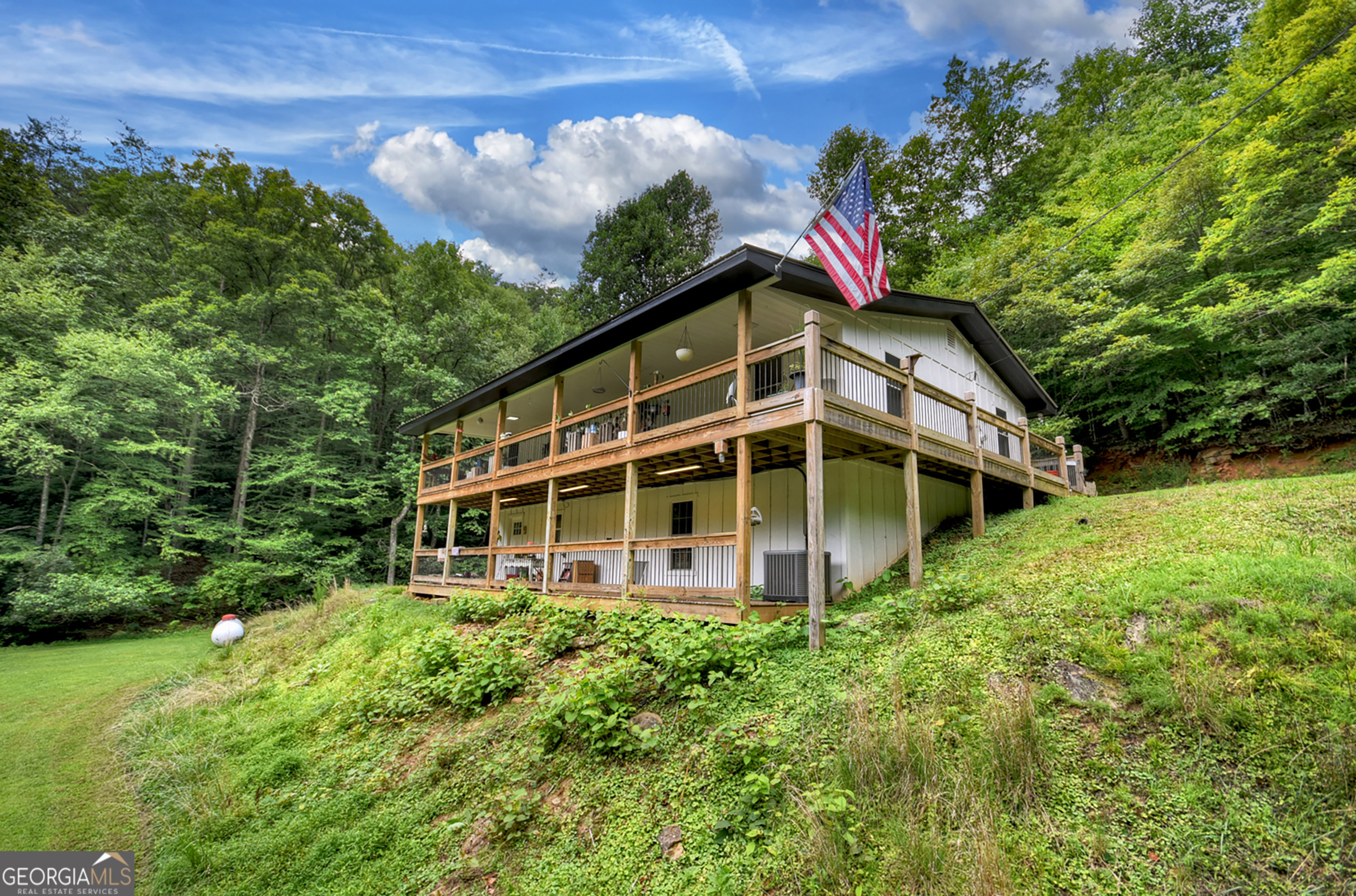 Five Bedroom Home on 3.37+/- acres with Stream Welcome to this beautiful home on a peaceful, private setting with 3.37+/- acres of serene mountain land. With five spacious bedrooms, two full bathrooms, and nearly 2,500 sq ft of living space, this property is perfect for families, a mountain retreat, or investment potential. Step inside to find a bright open-concept living area with a cozy fireplace and large windows bringing in natural light. The newly renovated kitchen features white cabinetry, subway tile backsplash, stainless steel appliances, and plenty of counter space for cooking and entertaining. The main level offers multiple bedrooms and a stylish full bath with double vanities, while the lower level provides additional finished space, ideal for guests, hobbies, or a private office. A dedicated laundry/mudroom adds convenience. Enjoy the outdoors with two levels of expansive covered porches overlooking the property, perfect for relaxing and listening to the sounds of the branch that runs through the land. A storage shed is also included for tools and equipment. This move-in-ready property combines modern updates with mountain charm - all just a short drive to the shops, dining, and outdoor adventures of Blue Ridge.
