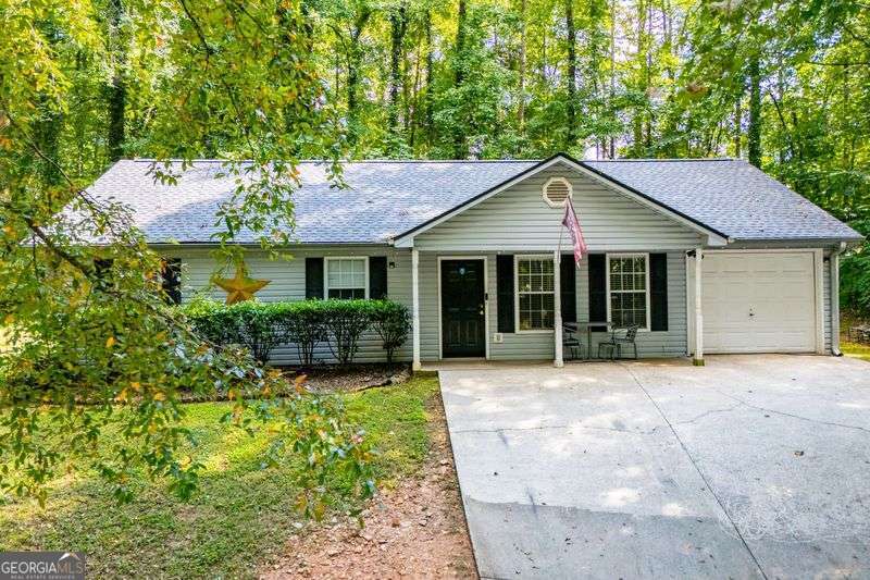Adorable stepless ranch with so many updates! New roof, new vinyl plank flooring, beautiful new tile baths, new water heater, generous kitchen cabinets with a pantry. This home is super-low maintenance, very convenient to shopping, restaurants and schools. Private backyard with privacy fence, but backs up to the coveted Silver Comet trail! hot tub in the backyard. This darling home is priced right to sell and won't last --