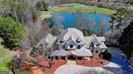 Garden and Gun Dream Home GATED ESTATE on combined 88+ stunning pristine acres with 2 meticulously designed PRIMARY HOMES (6600sf+8,077sf), THIRD RENOVATED GUEST COTTAGE (1800sf approx), separate PRIVATE RECREATION BUILDING/INDOOR GYM, FENCED MAINTAINED PASTURES, and a TROPHY 5-ACRE FISHING LAKE with PRIVATE DOCK. OWNER FINANCE OPTION! 5 Miles from LAKE LANIER. Enter through the stone-gated entrance, where tree lined paved driveway and professional landscaping lead to the main estates, which are privately centered on the property. The stacked-stone covered porch and circular driveway welcome you, with ample parking for guests & events. The professionally designed interior features light neutral tones and a two-story stone fireplace in the great room. Incredible recently designed butler's pantry and coffee/wine bar. The main entrance leads to a library/office with custom furniture grade built-in shelving, a spacious dining room, and a completely remodeled chef's kitchen with Thermador appliance package and sub-zero refrigerator, quartz counters, and new lighting. Expansive windows and balcony french doors offer views of the property and lake. The breakfast room flows into the Great Room with furniture grade built-ins and a flat-screen wiring pkg above the fireplace. The Owner's Suite is on the main level with terrace access, a custom-designed walk-in closet, and a spa-inspired bath with heated floors. The main level includes a perfectly located guest half bath. Upstairs, find four bedrooms and three full baths, including two ensuites. The loft area is customized with bunk beds and offers easy conversion to traditional massive guest suite potential. The upstairs features a spacious private loft seating area lounge. The lower finished terrace level features a custom butcher block island bar, second kitchen, family room, billiards area, 2 full baths, guest ensuite bedroom, and a sliding barn door leading to a massive secure storage discrete fresh air concrete bunker-perfect for a wine cellar, safe storage, or shooting range. The creative possibilities are endless. The lower terrace level opens to a screened porch the entire length of the home, and an infinity custom pool design option overlooking lake. A trex deck and boardwalk lead to the private dock and TROPHY BASS LAKE, designed by Aquatic Environmental Services. The lake is its own ecosystem including investment into Electofish research, 5 feeders, bluegill, crawfish, trout, strain bass, grass carp, as well as a pebble bottom and appropriate aquatic plant life. The property has herds of trophy bucks and deer. The primary estate home includes water purification, fresh air ventilation, and dehumidification. 2nd MAIN RANCH HOME WITH POOL: 7 total ensuite bedrooms and 7 baths featuring an owner's suite with fireplace, Spa inspired bath with soaking tub, tile shower, heated floors, and his/hers custom closets.Woodgrain tiles and new lighting! POOL! Home generator! GUEST COTTAGE: A 2-bed, 2-bath caretaker or guest suite cottage with private driveway and views, covered front porch and spacious accommodations overlooking large pasture. PRIVATE GYM REC BUILDING: Features a basketball/pickleball court, golf simulator room, kitchen, and two bathrooms with spaces for exterior expansion ideas like tennis or outdoor rec/barn. The land features fenced pastures and a smaller pond ideal for a home site, barn, equestrian facilities, gardens, or homesteading. There is a chicken coop! What is your vision? The estate is close to Lake Lanier, private airports, Falcon Training Camp, UGA campus, wineries, vineyards and more. The driveway provides easement to a neighboring 52-acre estate that is also on market with different office, for those interested in a combined 88+ acre compound. Call today for an appointment. We are here to help! Be sure to interact with the virtual tour here! (2 estates sold as combined or individually, call for details).