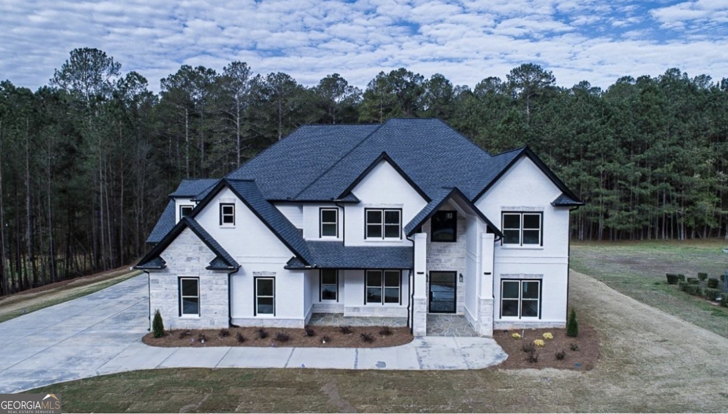 The Manor at Smithtown An Exclusive Collection of Six Custom Luxury Estates in the Heart of Suwanee The Manor at Smithtown is an intimate enclave of six exquisitely designed traditional residences where timeless architecture meets modern sophistication. Situated on sprawling homesites-each over one acre, with the custom estate on over four acres-this community offers three elevated floorplans thoughtfully crafted for the discerning buyer seeking both elegance and comfort. Featured Floorplans: The Joshua Plan Two Owner's Suites - one on the main level with direct access to the backyard, and a second, expansive suite upstairs with oversized walk-in closets and a spa-inspired bathroom featuring a standalone soaking tub. A breathtaking two-story Great Room with a soaring fireplace feature wall and a wall of windows flooding the space with natural light. Chef's kitchen complete with a gas cooktop, wall oven, microwave, and custom vented hood, complemented by a pet spa conveniently located in the garage. Upstairs, enjoy a spacious loft area and three secondary bedrooms. The Zarah Plan An open-concept design featuring an Owner's Suite on the main level, formal dining room, and an impressive two-story family room framed by a dramatic wall of windows. Gourmet kitchen featuring striking quartz countertops, an oversized island, and a full Prep Kitchen with cooktop, custom pantry cabinetry, and additional vented hood. Oversized glass sliders open to an extended, covered patio finished in tile-perfect for al fresco dining and effortless entertaining. Upstairs offers an office, loft, and thoughtfully designed secondary ensuite bedrooms including a Jack-and-Jill configuration. Includes a pet spa for added convenience. The Custom Estate Plan (Site 6) This executive estate is positioned behind a refined, stately gated entry, showcasing a sprawling driveway lined with lush landscaping and towering trees. Fully customizable, this floorplan offers endless possibilities - from oversized closets to dual two-story living spaces, expansive covered patios, and luxury amenities curated to your exact vision. Every elegant upgrade imaginable can be integrated, making this home a true masterpiece of design and privacy. Unparalleled Location Situated in the vibrant city of Suwanee, Georgia-consistently ranked as one of the best places to live in America-residents will enjoy proximity to top-rated Gwinnett County schools, premier shopping, fine dining, award-winning parks, and extensive walking trails. Developed by Nick & Brothers Renowned for excellence in luxury home development, Nick & Brothers deliver unmatched craftsmanship, timeless design, and extraordinary attention to detail. Estimated Completion: Late September 2025 Exclusive Buyer Incentives: Take advantage of generous seller concessions when using our preferred partners: Mortgage Lender: Toshia Parrish with Assertive Mortgage Closing Attorney: The Hawes Law Firm Please Note: Completed photos are representations of previous builds and are provided for illustrative purposes only. Only six opportunities exist to own one of these remarkable homes. Don't miss your chance to live, relax, and thrive at The Manor at Smithtown.