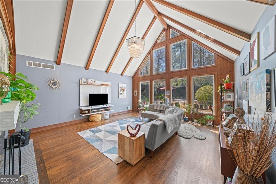 Come see this rare 5-bedroom, 3.5-bath Tudor home in East Cobb. This property is an entertainer's dream, featuring an open floor plan and a beautiful backyard with a patio, deck, and pool. The vaulted living room boasts dramatic floor-to-ceiling windows and a cozy fireplace, while an additional great room offers another fireplace, creating an ideal man cave or family space. The open kitchen has a butcher block breakfast bar, granite countertops, a tiled backsplash, and ample storage. The master suite, conveniently situated on the main level, includes a spacious soaking tub. A loft area adds extra living space, and a two-bedroom in-law suite completes the downstairs. This home also features privacy shades on the front windows and an electronic entry gate.