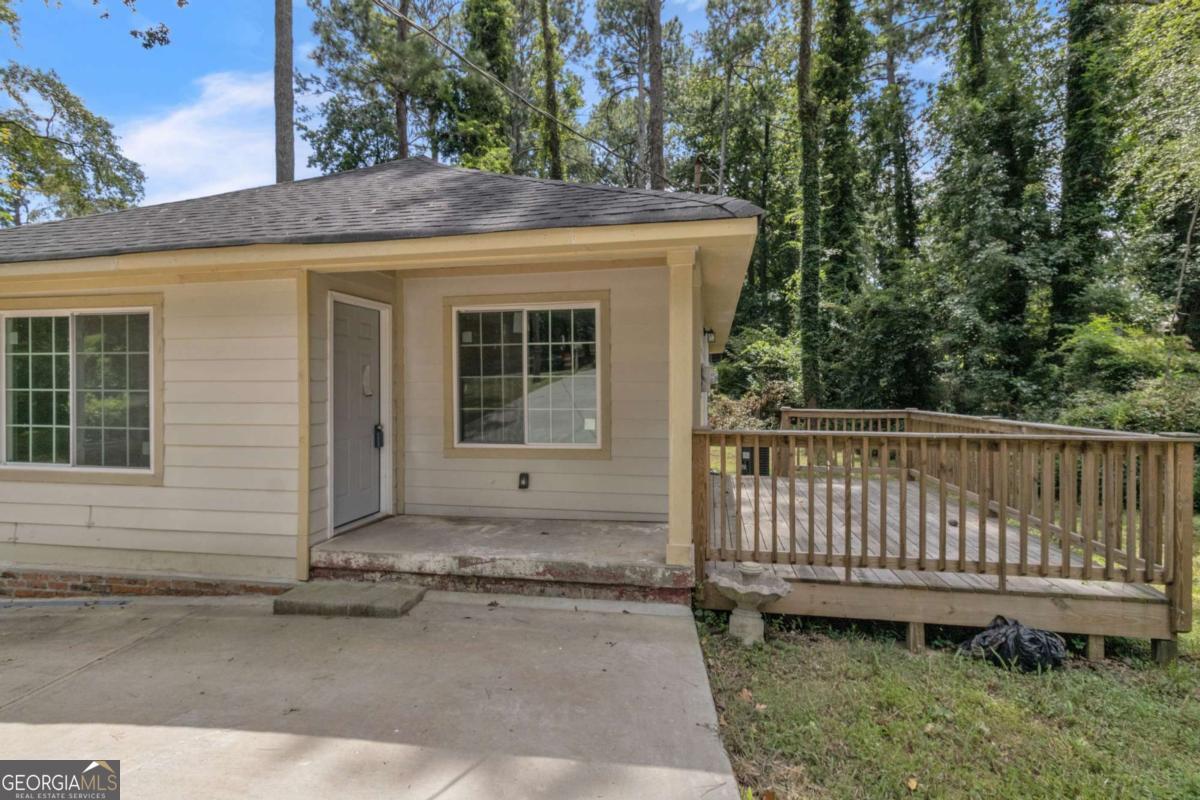 Renovated 3BR/2BA home on a spacious wooded lot! Featuring new floors, updated kitchen, stylish bathrooms, and fresh paint, this property already offers great potential. Please note: the home is not fully finished and still requires some work, giving buyers the chance to add their own final touches. Open layout with dining area, private deck, and long driveway with ample parking. Perfect for first-time buyers, families, retirees, or investors. Convenient to schools, parks, shopping, MARTA, I-75, and just minutes from Hartsfield-Jackson International Airport.
