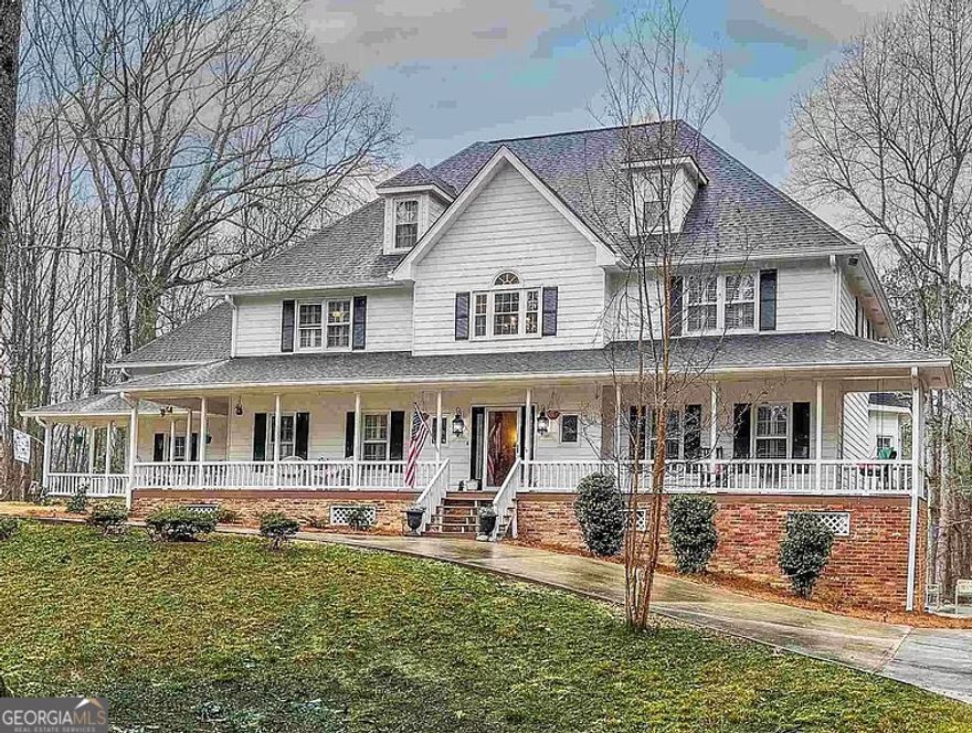 Welcome to the perfect blend of style and sophistication at this North Fayetteville estate, nestled on 4 private acres near Pinewood Studios. This home is designed for those who appreciate luxury, starting with its chef-inspired kitchen and complemented by a resort-style backyard with a lagoon-style pool, rock waterfall, and multi-level deck for entertaining.  The heart of this home is the gourmet kitchen, a true showstopper. Renovated to perfection, it features Calacatta quartz counter tops, a five-burner gas cook top, double ovens, a built-in drawer microwave, and a custom coffee bar. Whether you're hosting a lavish dinner party or a cozy family breakfast, this kitchen is as functional as it is beautiful.  Equally impressive is the primary suite, a private retreat that redefines luxury. Renovated in 2021, the spa-like bathroom is a masterpiece, boasting a freestanding soaking tub, an expansive walk-in shower, and skylights that bathe the space in natural light. The piece de resistance is the custom two-story walk-in closet, offering boutique-level storage with a built-in island, drawers, and a makeup station-a dream come true for any wardrobe enthusiast.  The rest of the home is designed to impress, from the 20-foot ceilings in the great room with a stunning masonry fireplace to the open loft library overlooking the main living space. Upstairs, you'll find four additional bedrooms, all with walk-in closets, along with a newly renovated en-suite bathroom and Jack-and-Jill bathrooms. A partially finished basement adds endless potential for a media room, game room, or an entire apartment.  This home delivers on every level-gourmet kitchen, luxury primary suite, and a backyard paradise-all wrapped in a timeless design. Schedule your private showing today and experience the exceptional lifestyle this estate has to offer.