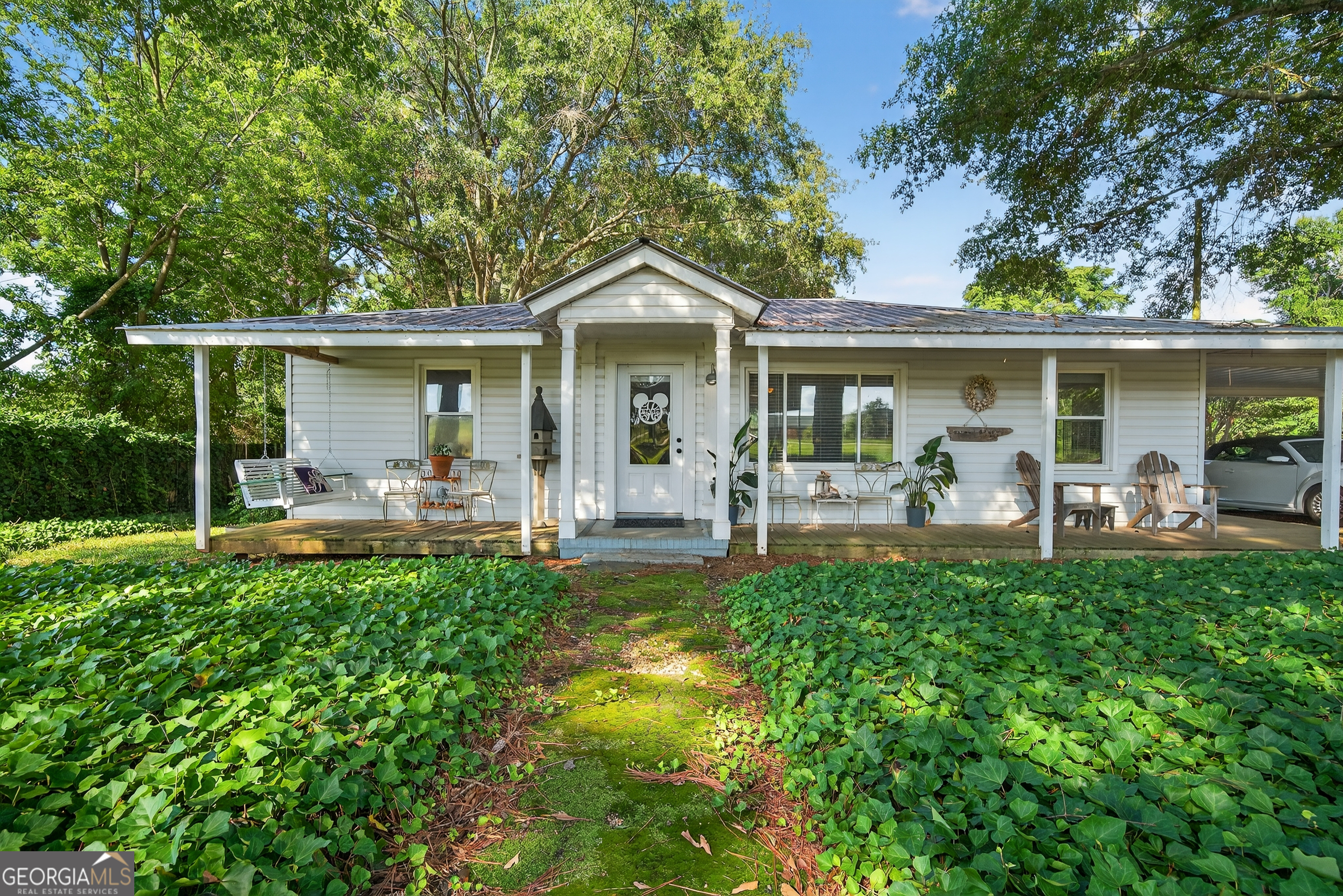 Storybook Cottage Retreat! Escape to this charming, remodeled two-bedroom, one & 1/2 bath cozy, cottage just outside of Forsyth. Featuring indoor & outdoor living spaces to enjoy. The well designed, interior remodel openned the main living floor plan while keeping the spacious bedrooms & adding a half bath. Rich pine & hardwood floors set the stage for cozy gatherings around a gas log fireplace with programmable thermostat. The adorable kitchen & dining area leads to outdoor porches & exterior living space. Just outside the laundry room, convenient to the kitchen is a grilling pavilion & outdoor shower to refresh after a summer day! You'll enjoy the outdoor greatroom with covered porch, masonry wood burning fireplace, sinks & kitchenette for ease of entertaining outdoors. And yes, there's a large workshop for tinkering around and storage of ATV's, lawn equipment, etc. Did I mention the Cozy "She Shed"? What a great place for your quiet time! The workshop & kitchenette area could easily be mofified to an in-law suite. The RV storage is supplied with 50 amp service & water. Perfect as a year-round residence, weekend get-a-way, or income producing rental with a blend of charm & enchantment!