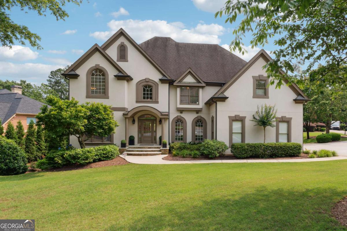 Step into a world of refined elegance at this luxury residence in the coveted Falls of Autry Mill swim-tennis enclave of Johns Creek. Set in a quiet cul-de-sac on a serene corner lot with a circular driveway, this home promises both endless entertaining opportunities and exceptional privacy. The heart of the home is a fully remodeled chef's kitchen, featuring a commanding 91/2-foot island, custom cabinetry, and top-tier Wolf dual-fuel range (six burners, double ovens, griddle). The vaulted, two-story great room showcases a dramatic marble fireplace, and panoramic windows flood the space with natural light. The spacious master suite offers a fireside sitting room, high ceilings, and dual walk-in closets. An expansive deck overlooks a resort-style backyard oasis complete with a saltwater pool, a heated four-season spa, and lush, professionally designed landscaping. The fully renovated terrace level includes a sophisticated home theater with stadium seating and pre-wired surround sound; an entertainer's kitchen with two under-counter refrigerators; and direct access to a large patio for seamless indoor-outdoor flow. A dedicated home gym and yoga studio (with gym flooring and a full wall mirror) offer serene pool vistas, which are perfect for wellness pursuits at any hour. Two private offices provide easy work-from-home settings, and a convenient second-floor laundry is adjacent to the generously sized secondary bedroom suites. Membership-style neighborhood amenities include 10 lighted tennis courts, 2 pickleball courts, 2 community pools, a splash pad, a children's playground, and a fully equipped clubhouse fitness center-all just steps from your door. Imagine your most sophisticated gatherings, tranquil retreats, and active-lifestyle days unfolding against this backdrop of luxury and leisure. This is more than a home-it's a lifestyle destination. Your invitation awaits at 100 Pine Mist Circle! Ideally located in a quiet corner of the neighborhood and with easy access to 10 tennis courts, 2 pickleball courts, 2 community pools, a playground, and the clubhouse fitness center all within the neighborhood, this home has it all! Imagine life at 100 Pine Mist Circle, a true dream come true in the #1 city to live based on US News World Report's latest ranking of US cities that came out in May 2025!